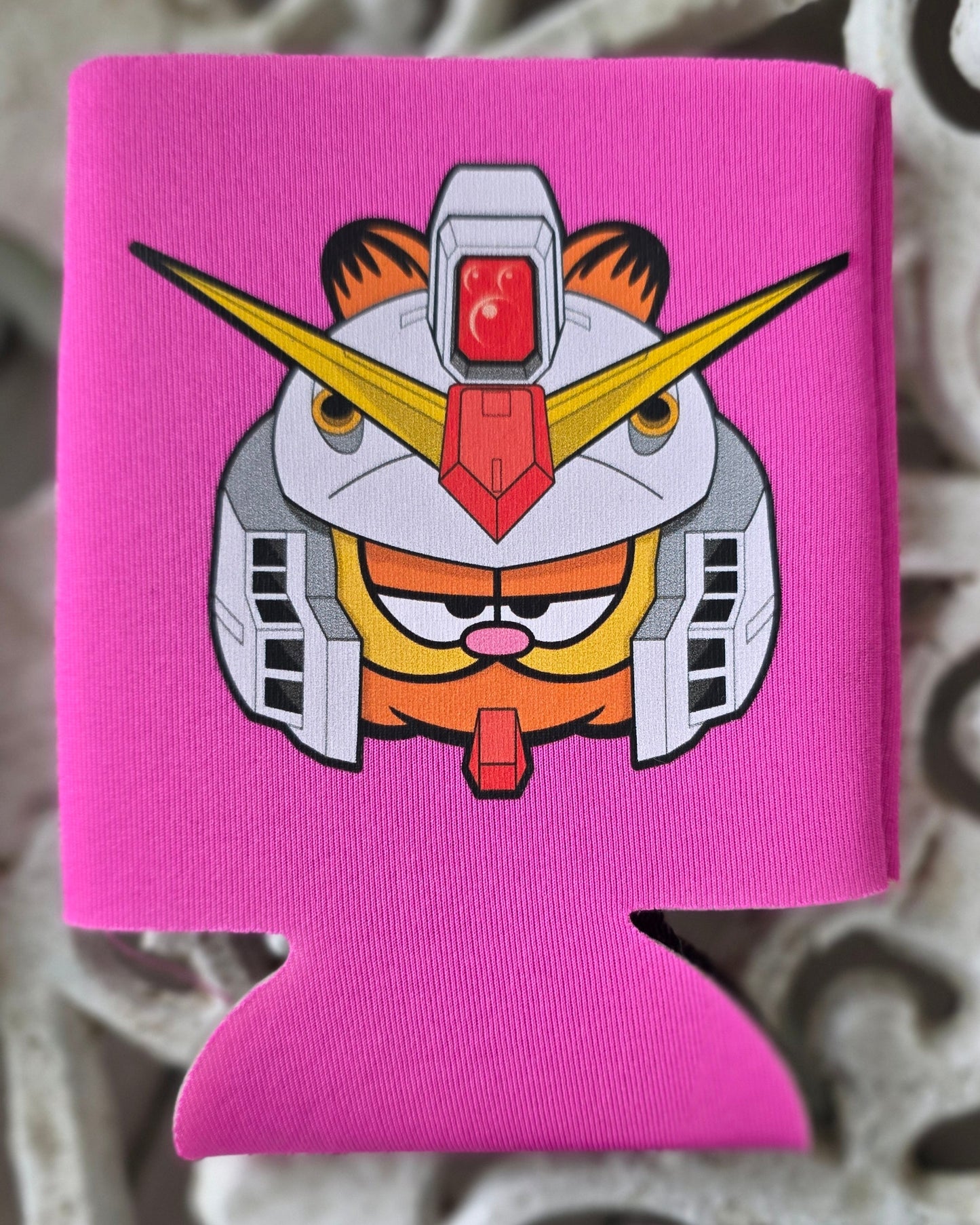Pink can cooler with a graphic design on a decorative metal surface
