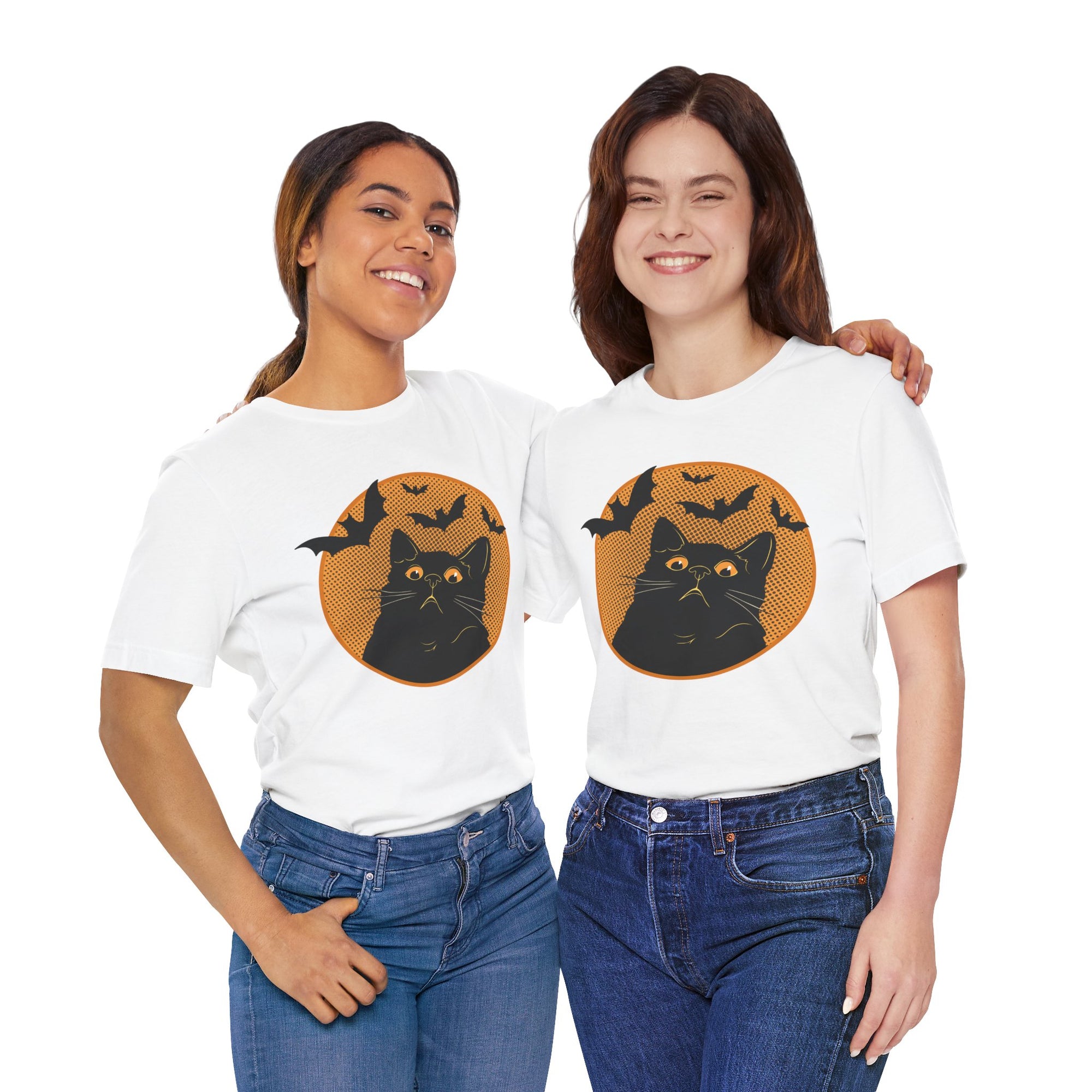 Two women wearing white t-shirts with a black cat and bat design on a white background