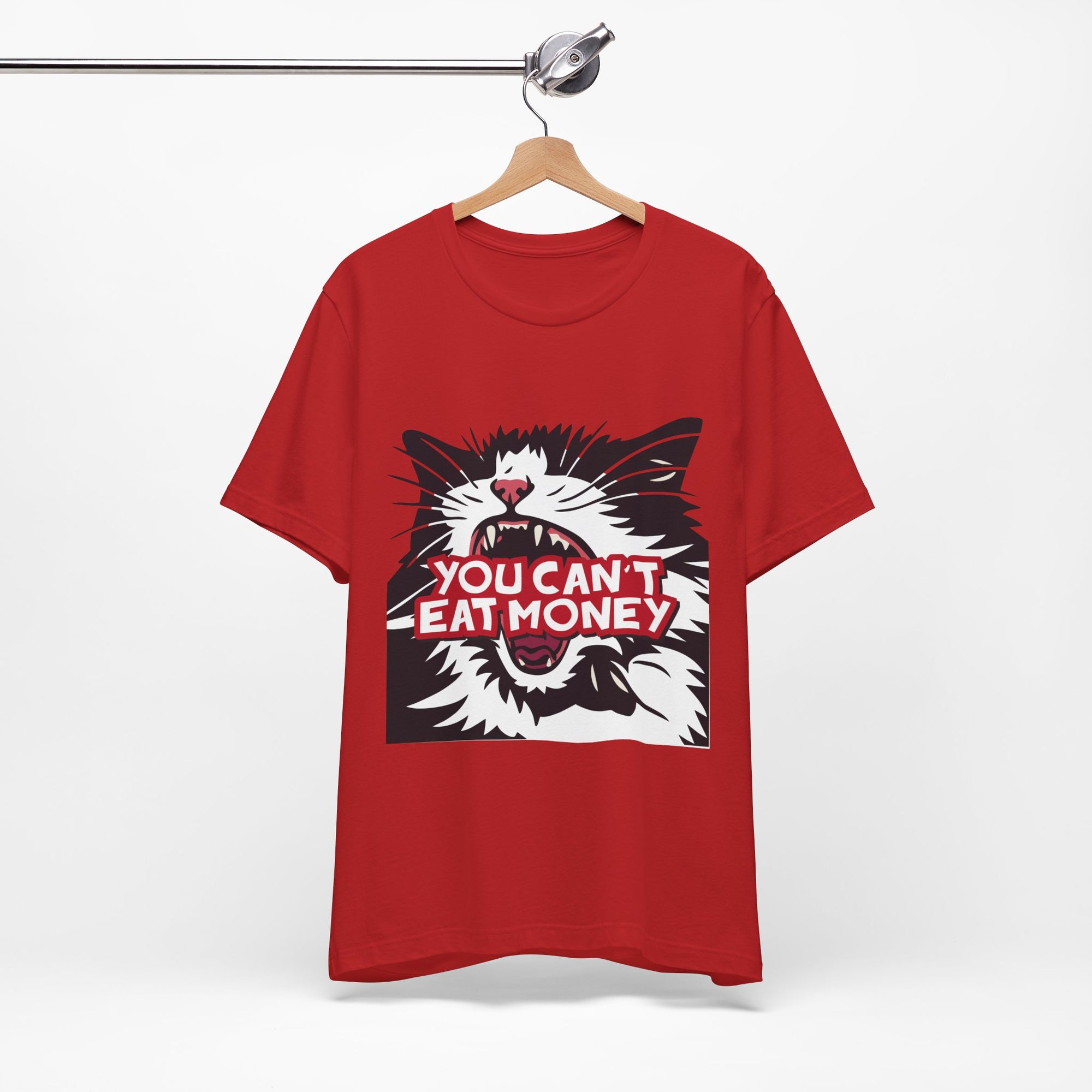 red t-shirt featuring a bold black, white, and red angry cat graphic with the phrase “You Can’t Eat Money.”
