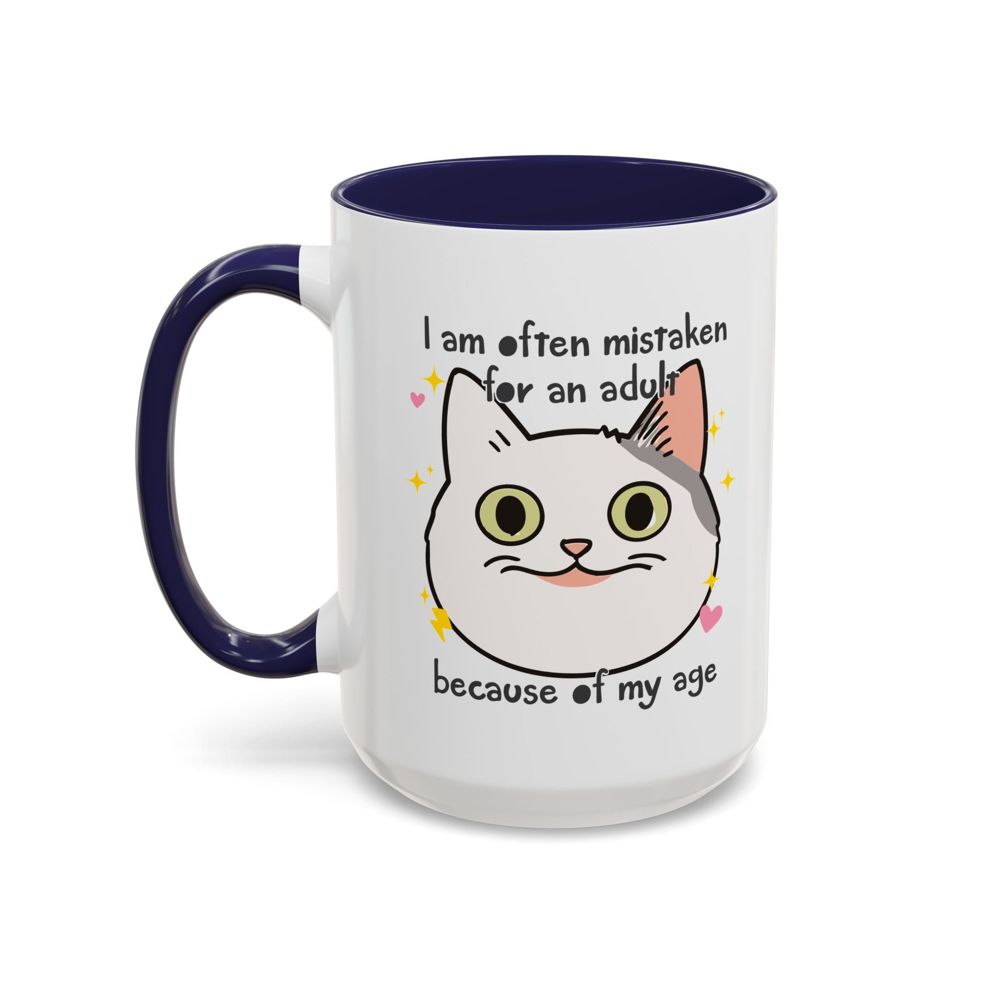 White ceramic mug with purple handle and interior featuring a cute wide-eyed cat face, hearts, sparkles, and the phrase “I am often mistaken for an adult because of my age.”

