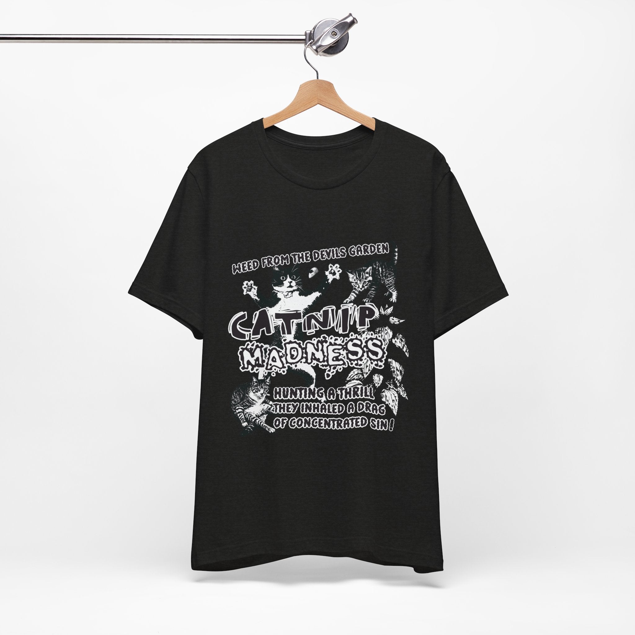 Black t-shirt with white graphic design on a hanger against a white background