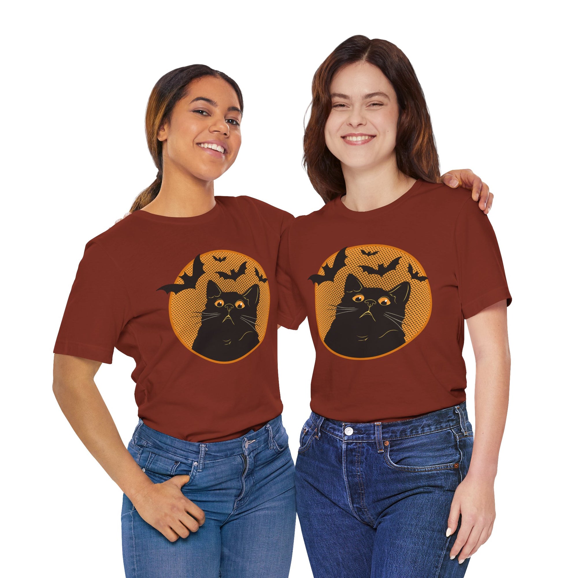 Two people wearing maroon t-shirts with a black cat and bats design on a white background
