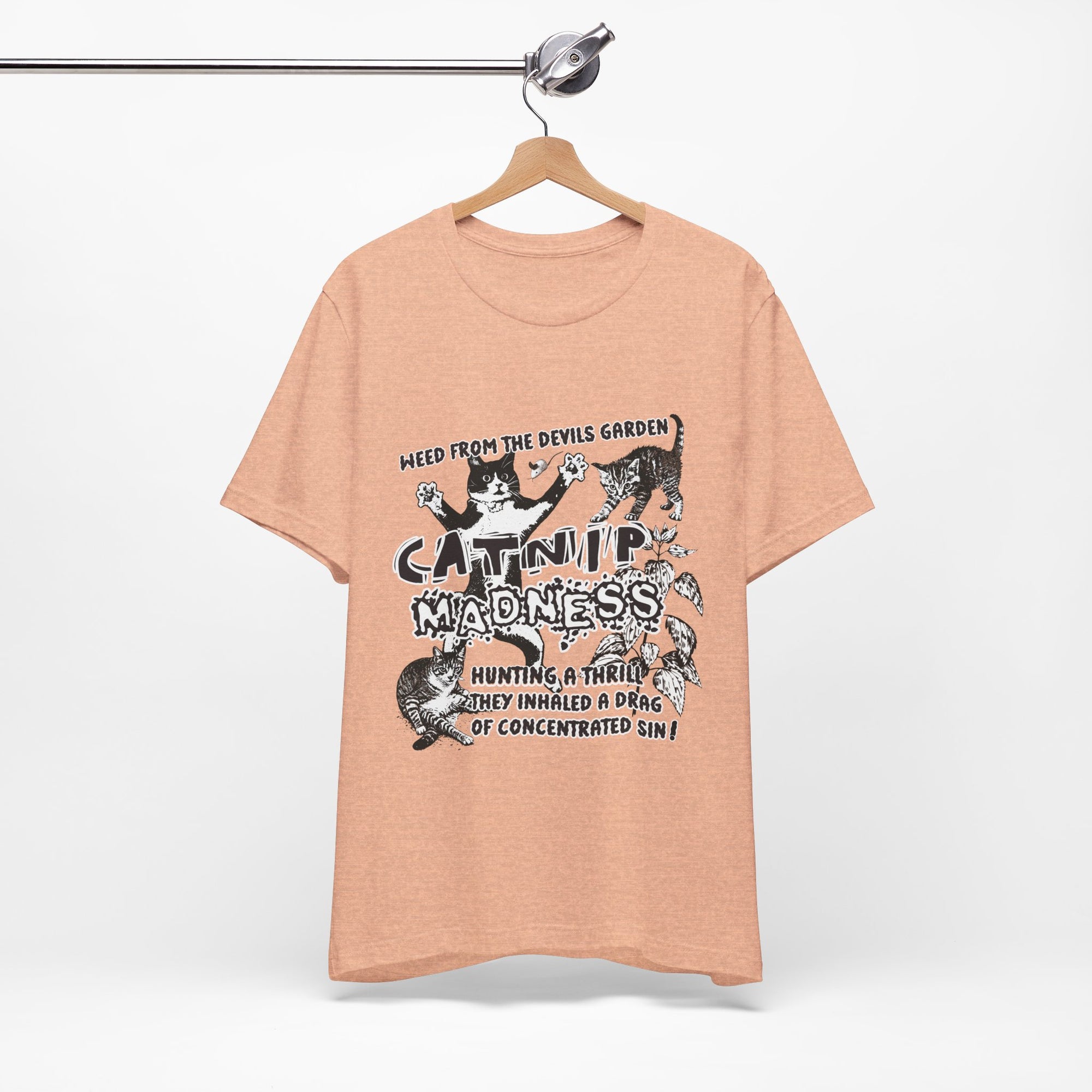 Beige t-shirt with graphic design and text on a hanger against a white background