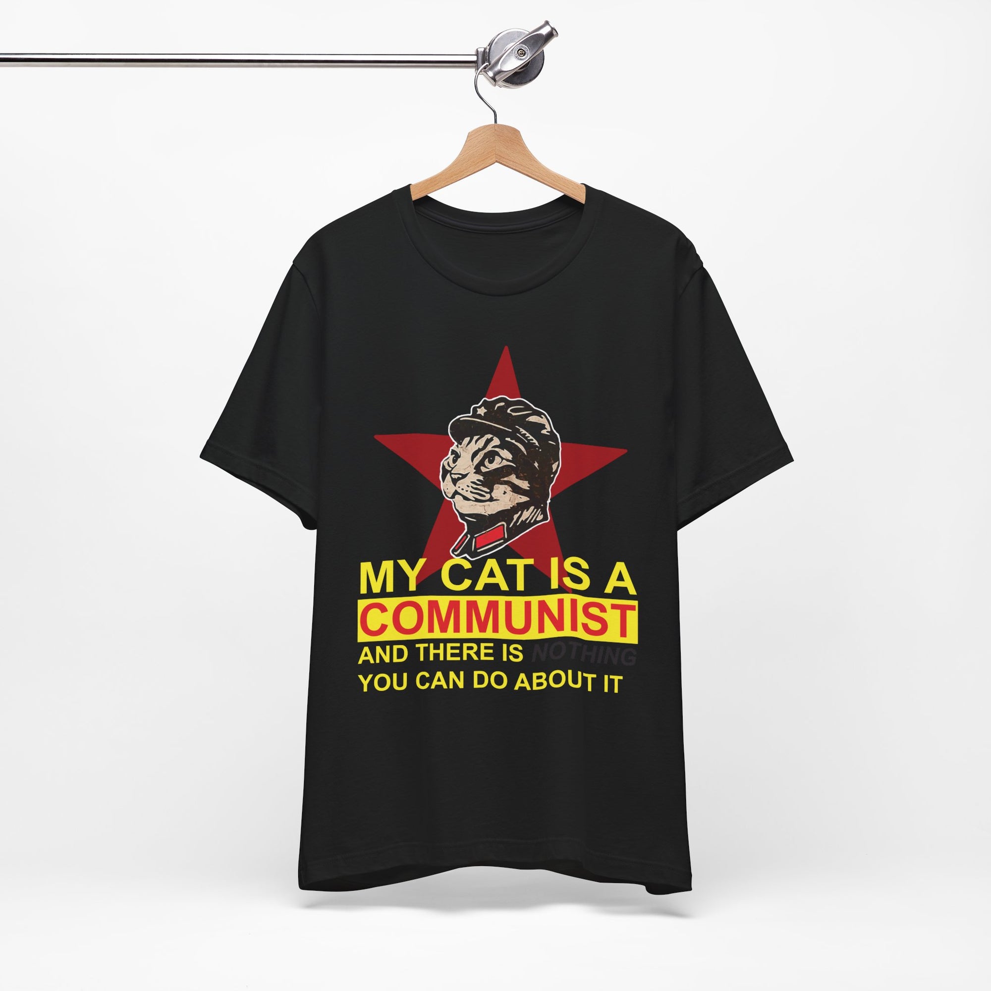 Black t-shirt with a graphic of a cat in a communist uniform and text on a hanger against a white background