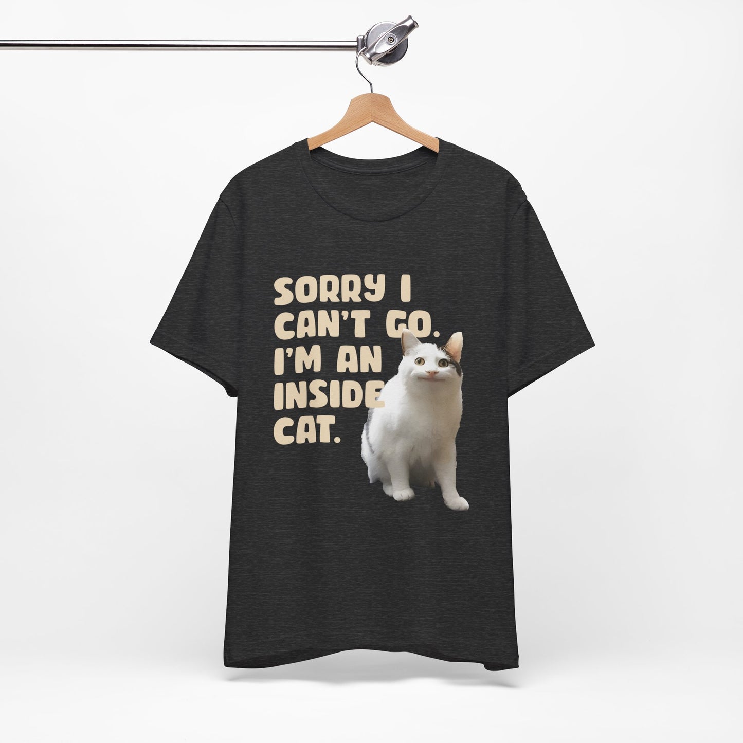 Black t-shirt with a white cat graphic and text on a hanger against a white background