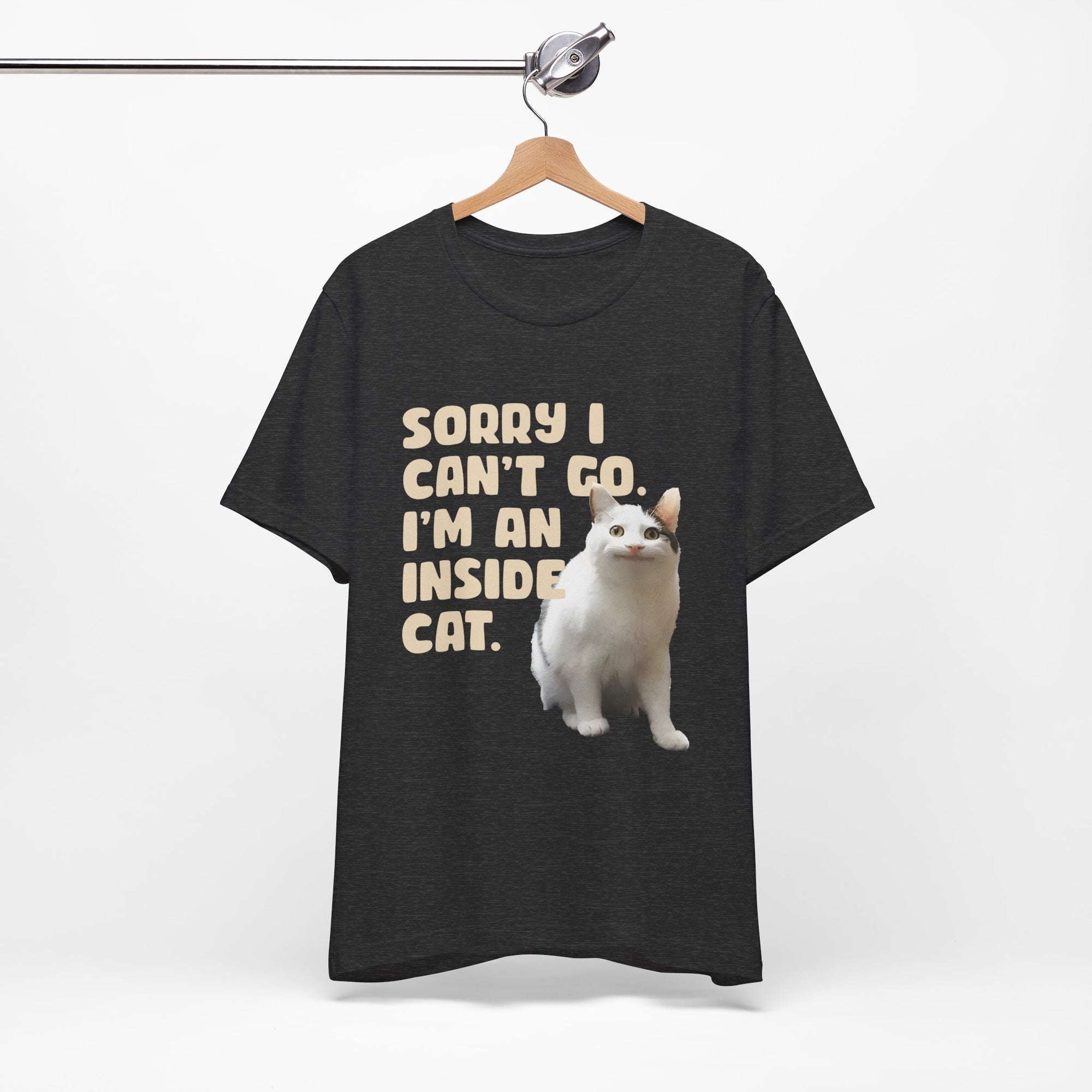 Black t-shirt with a white cat graphic and text on a hanger against a white background