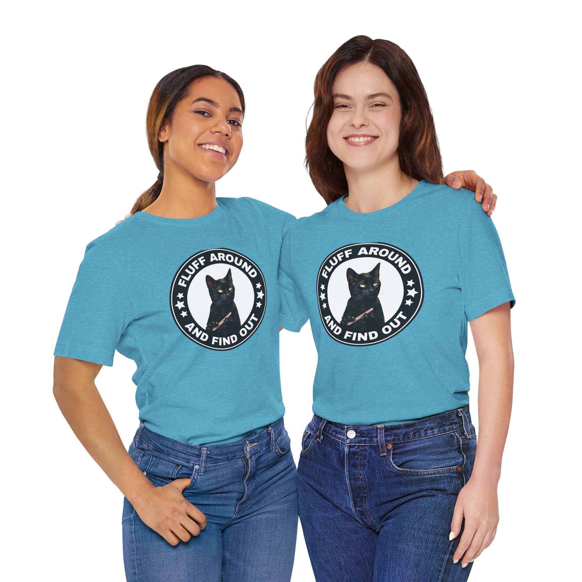 Two people wearing matching blue t-shirt featuring a circular badge design with a black cat and the phrase “Fluff Around and Find Out.”