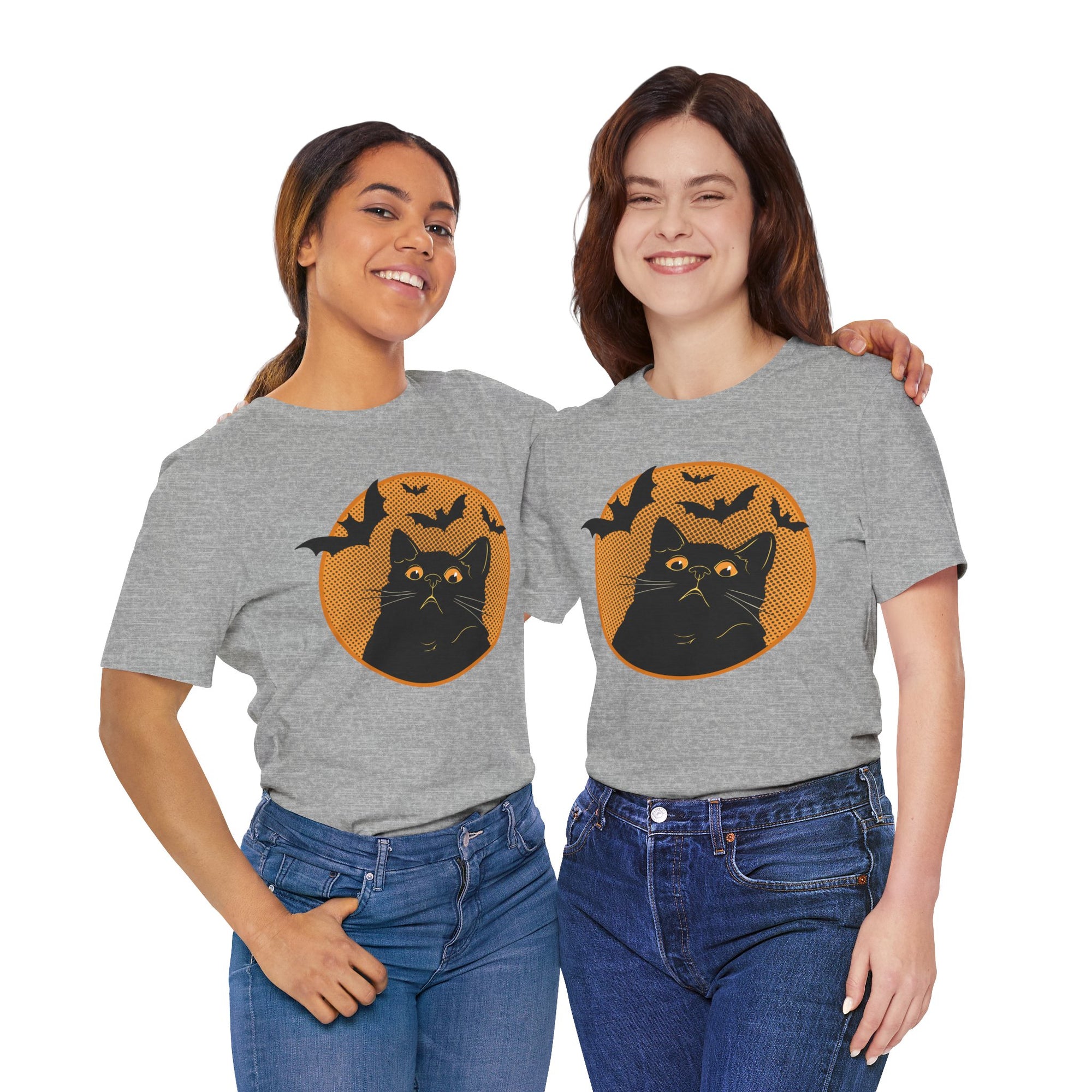 Two women wearing gray t-shirts with a black cat and bat design on a white background