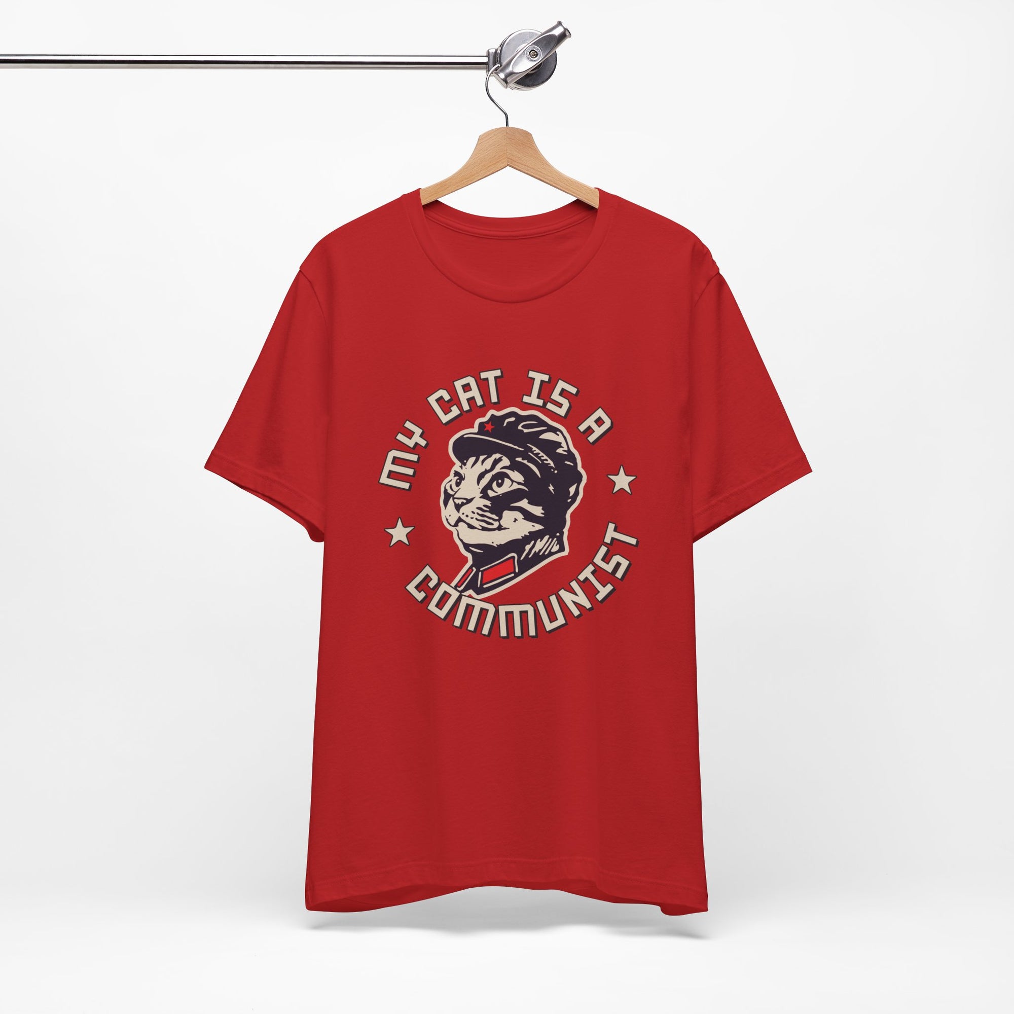 Red t-shirt with a graphic design of a cat and text on a hanger against a white background