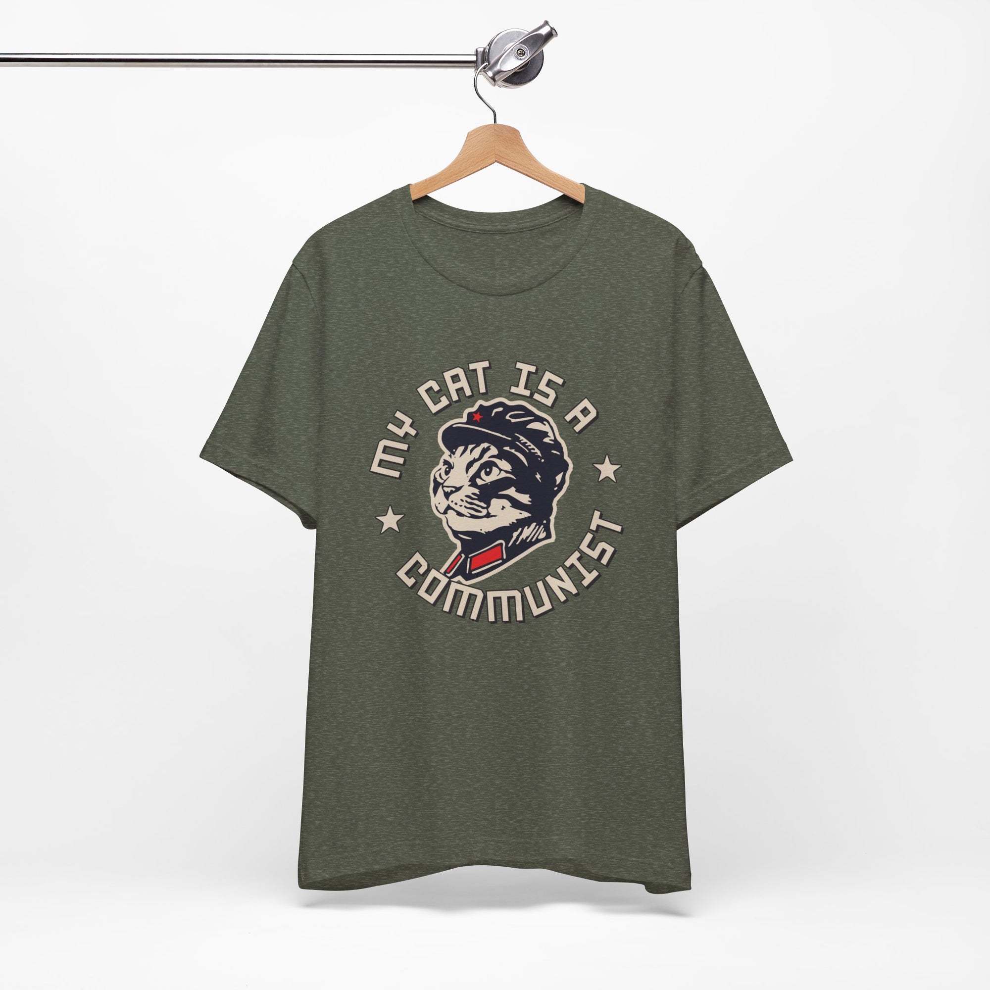 Green t-shirt with a graphic design of a cat and text on a hanger against a white background