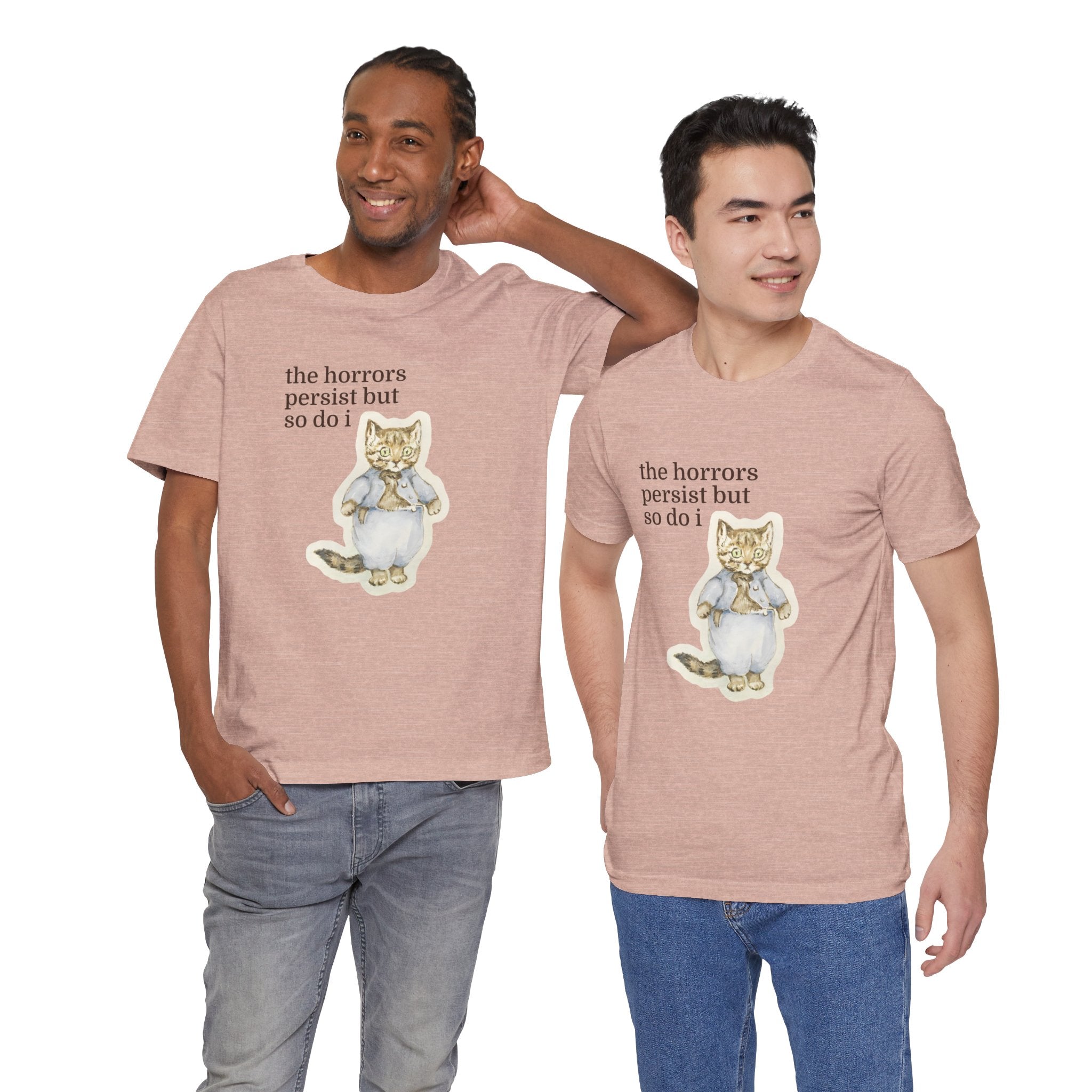 Two men wearing matching t-shirt featuring a vintage-style illustrated cat in blue clothing with the phrase “the horrors persist but so do i.”