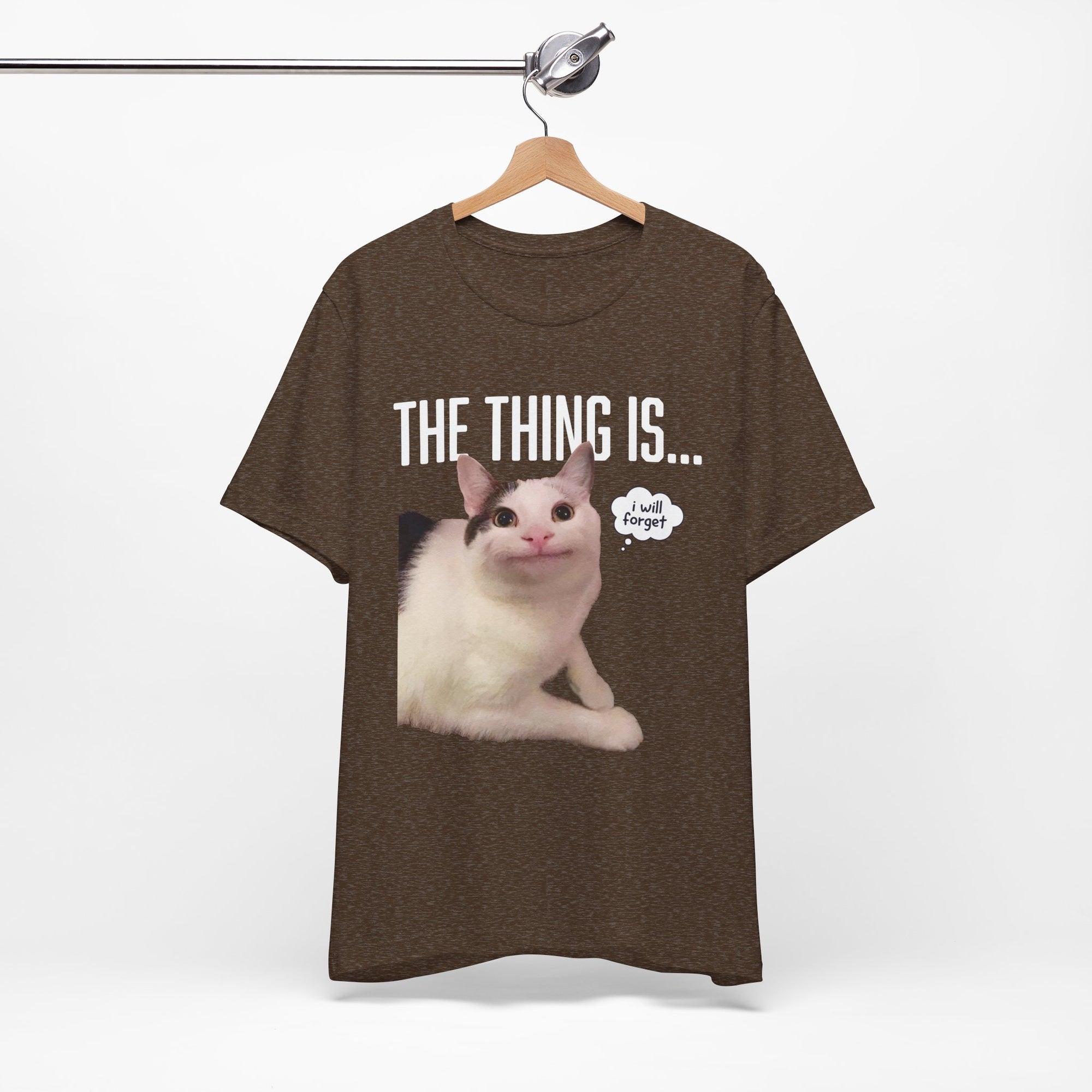 Black t-shirt with a cat graphic and text on a hanger against a white background