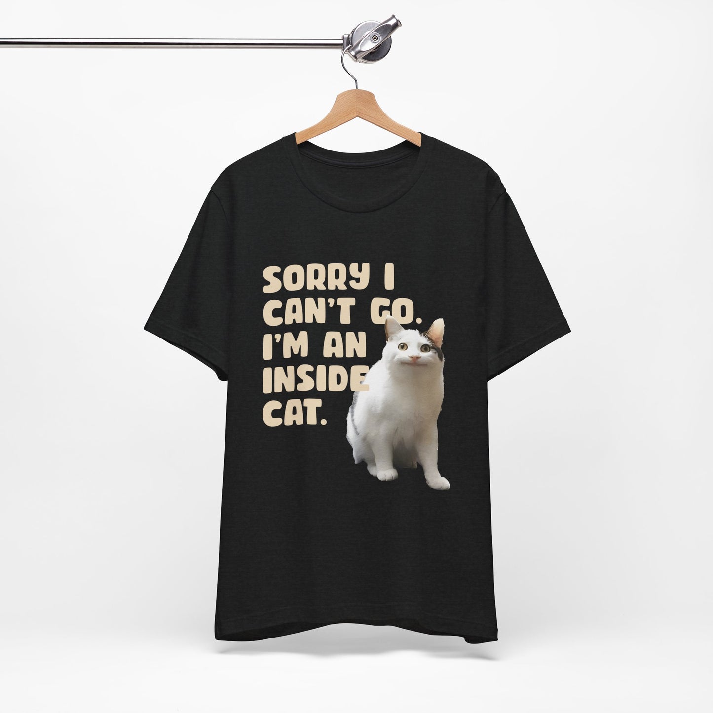 Black t-shirt with a white cat graphic and text on a hanger against a white background