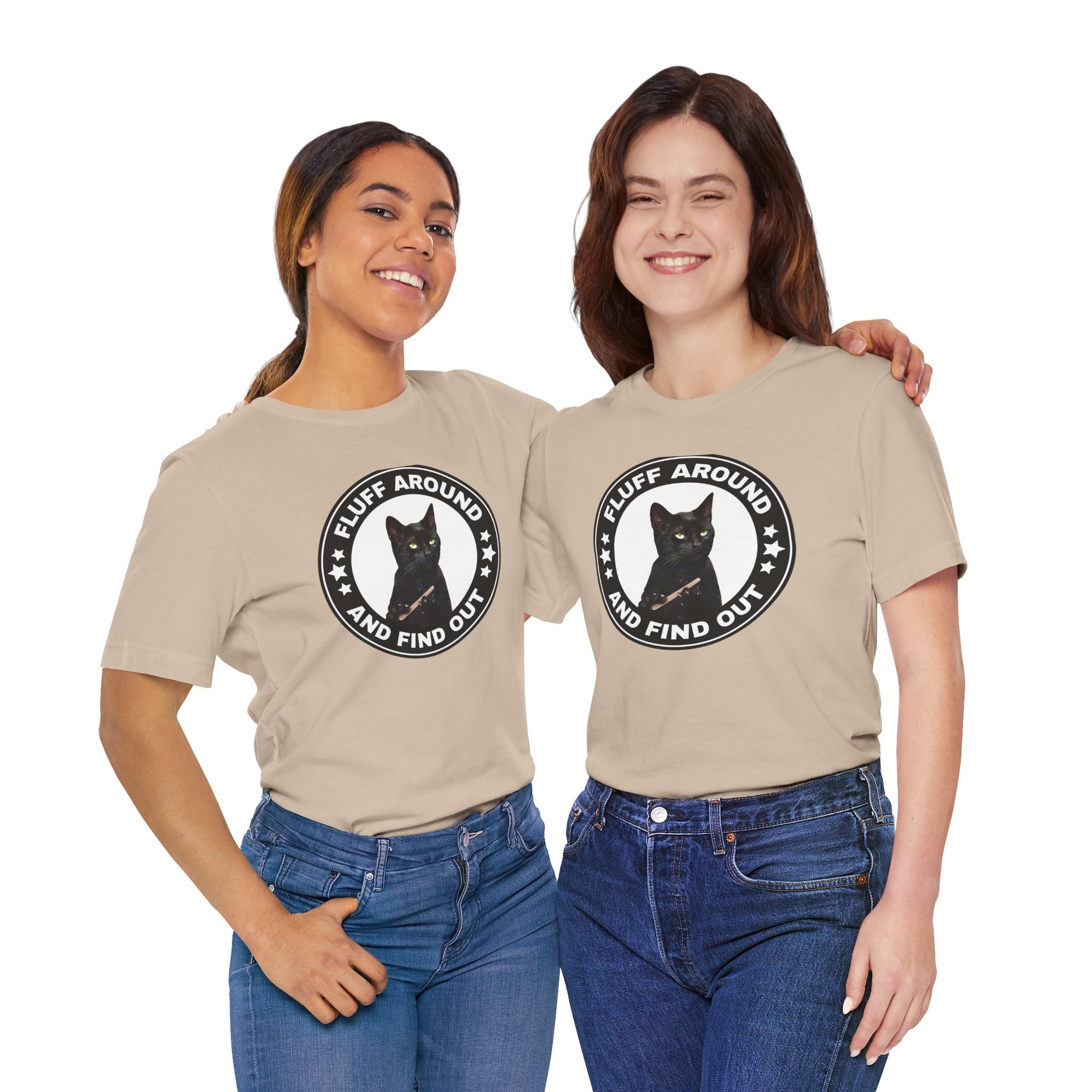 Two people wearing matching beige t-shirt featuring a circular badge design with a black cat and the phrase “Fluff Around and Find Out.”