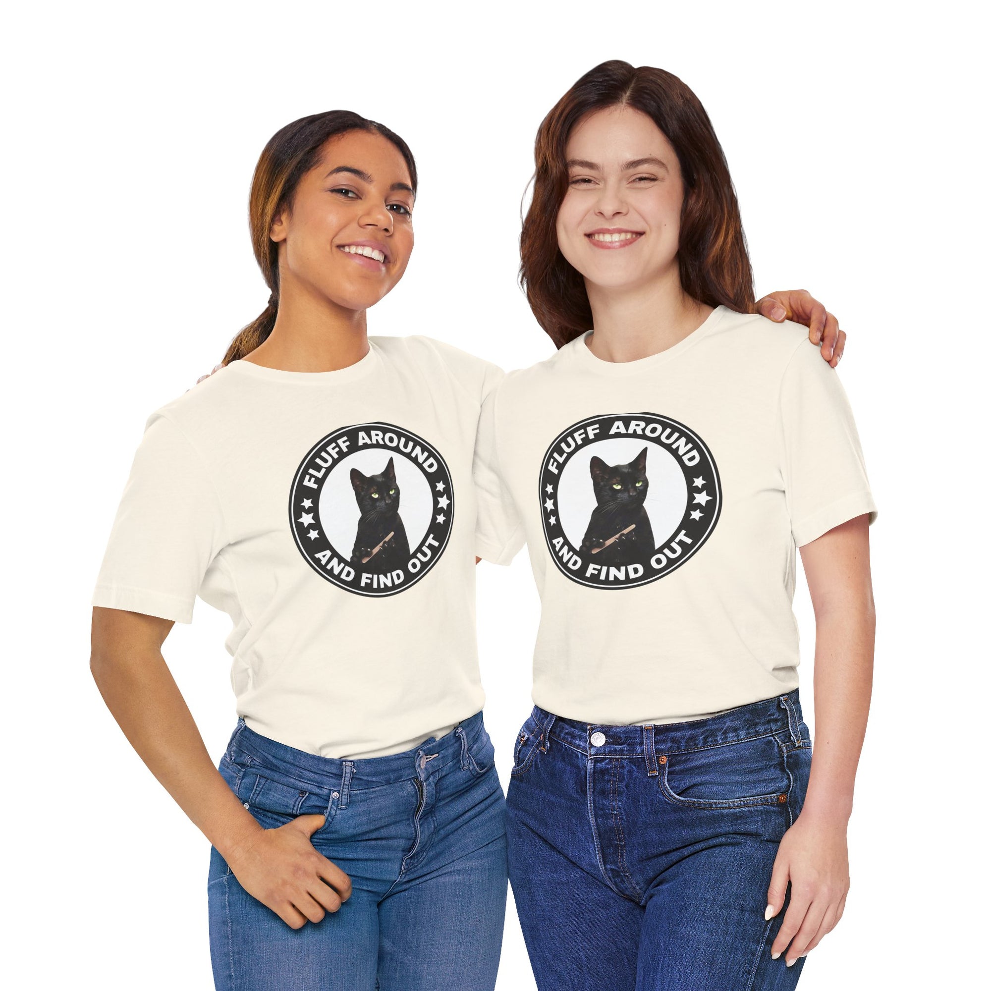 Two people wearing t-shirt featuring a circular badge design with a black cat and the phrase “Fluff Around and Find Out.”