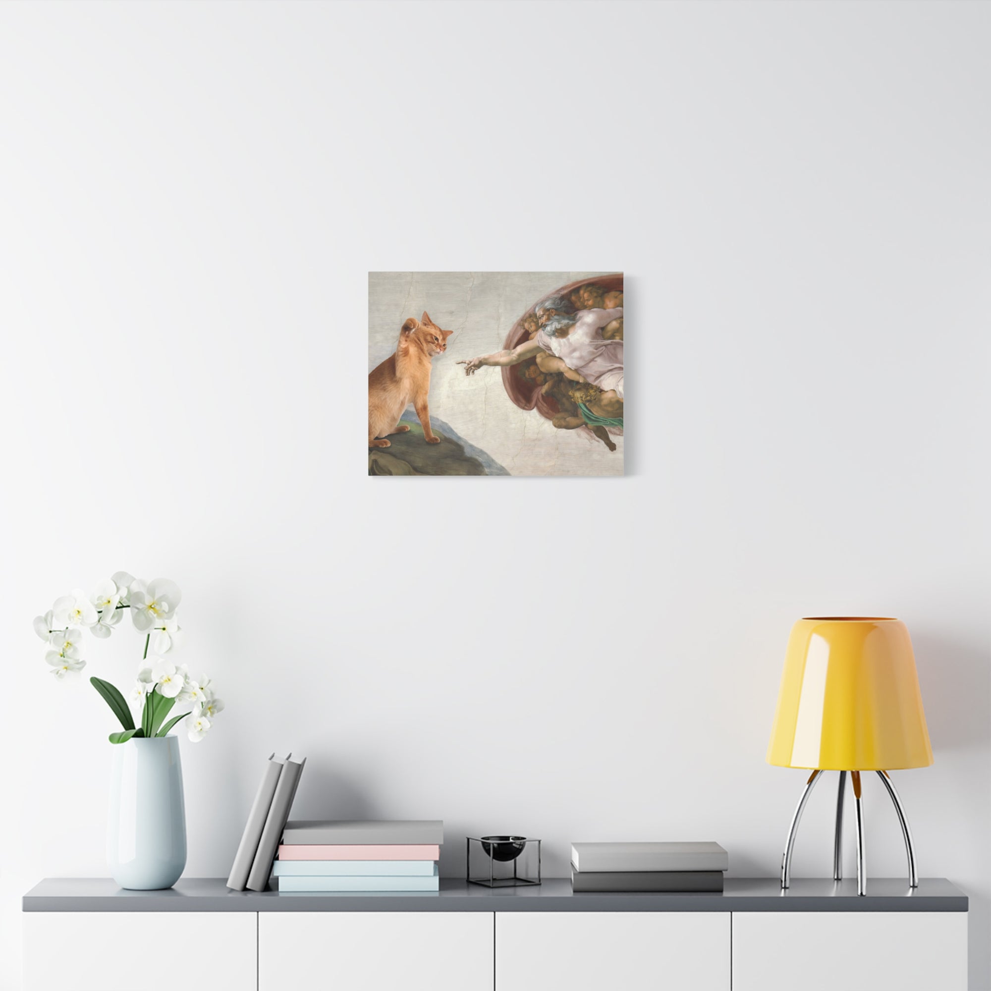 Framed artwork of a classical painting on a wall above a shelf with decor items.