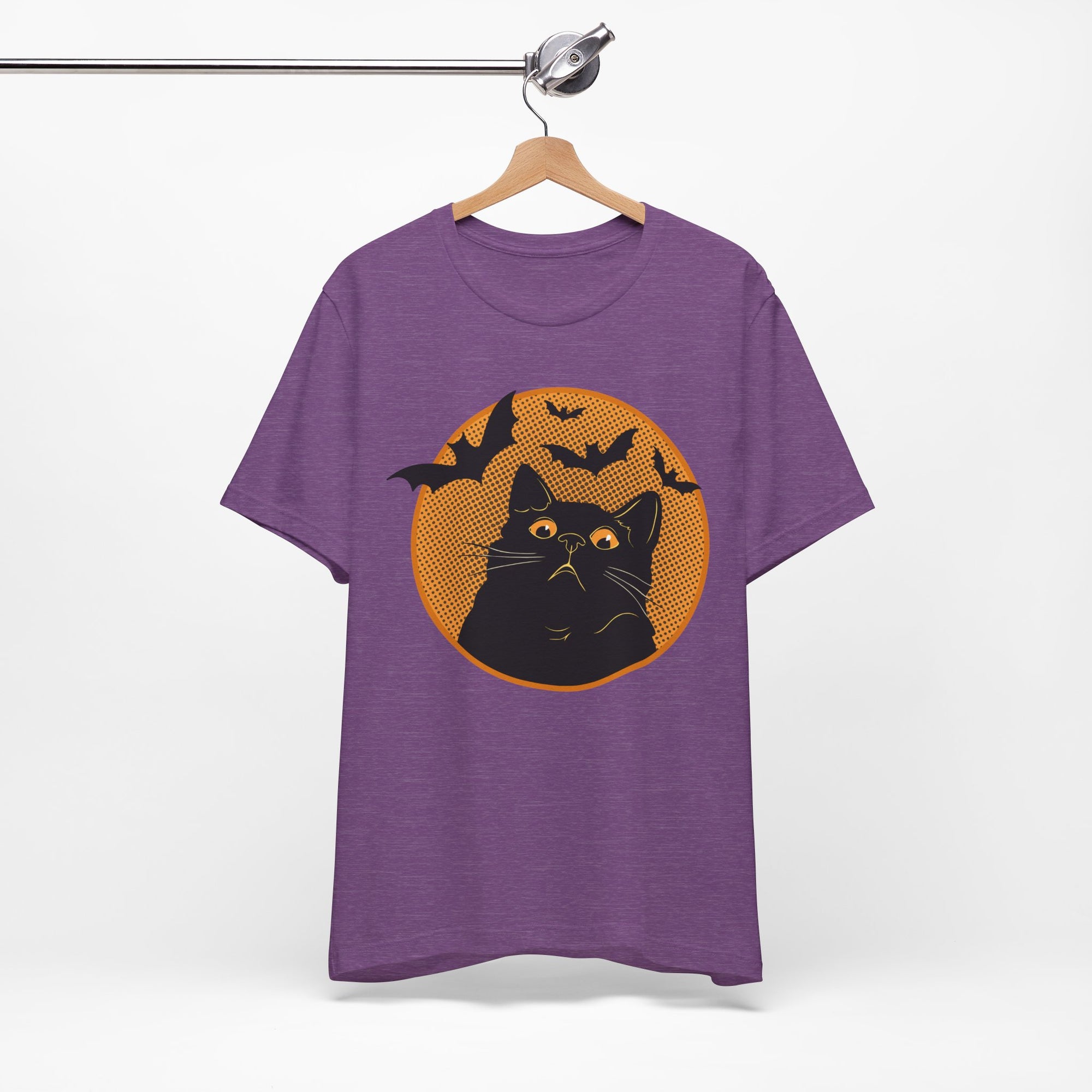 Purple t-shirt featuring a retro-style black cat graphic with orange moon, flying bats, and Halloween-inspired details.