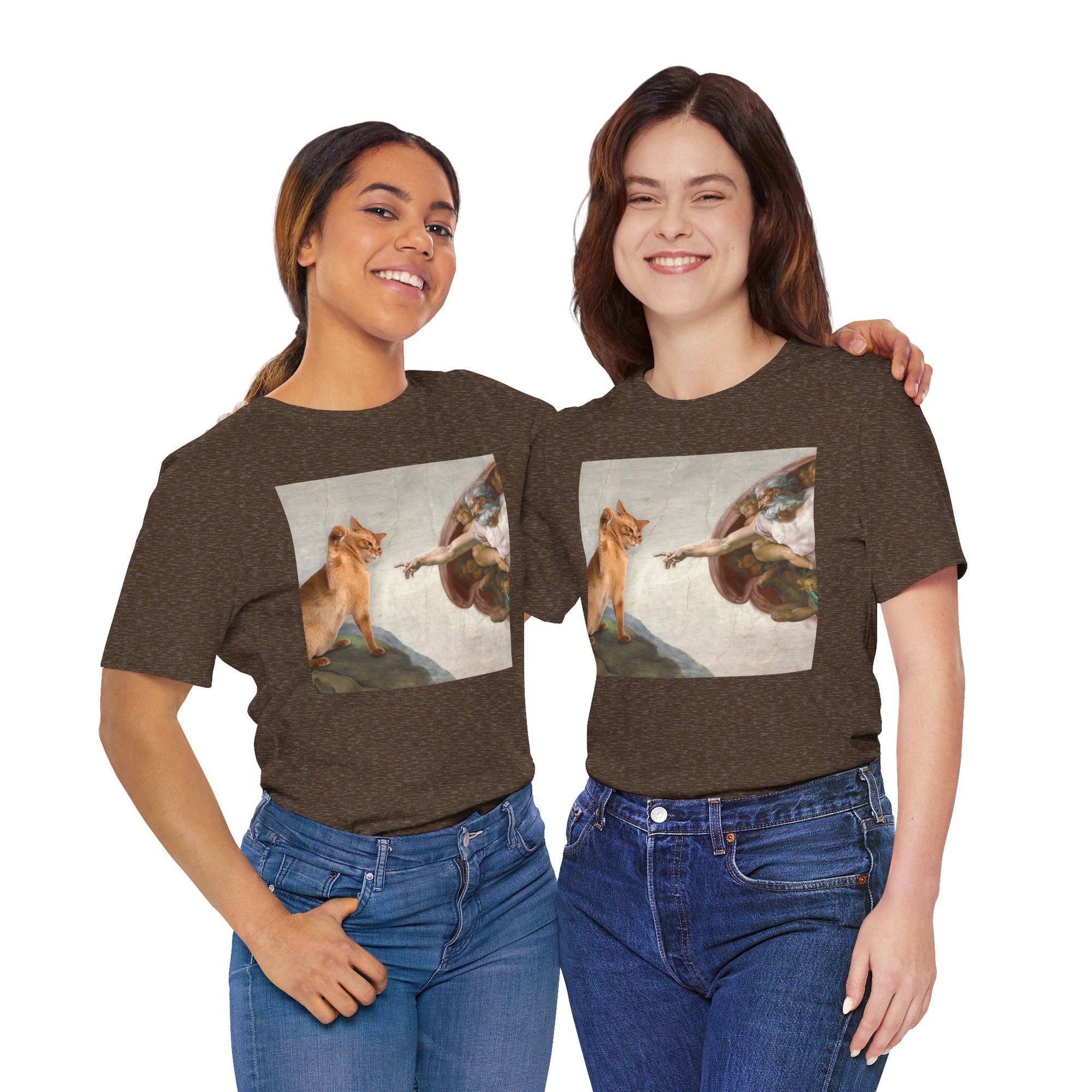 Two women wearing brown t-shirts with a graphic design of a fox and a person on a white background.