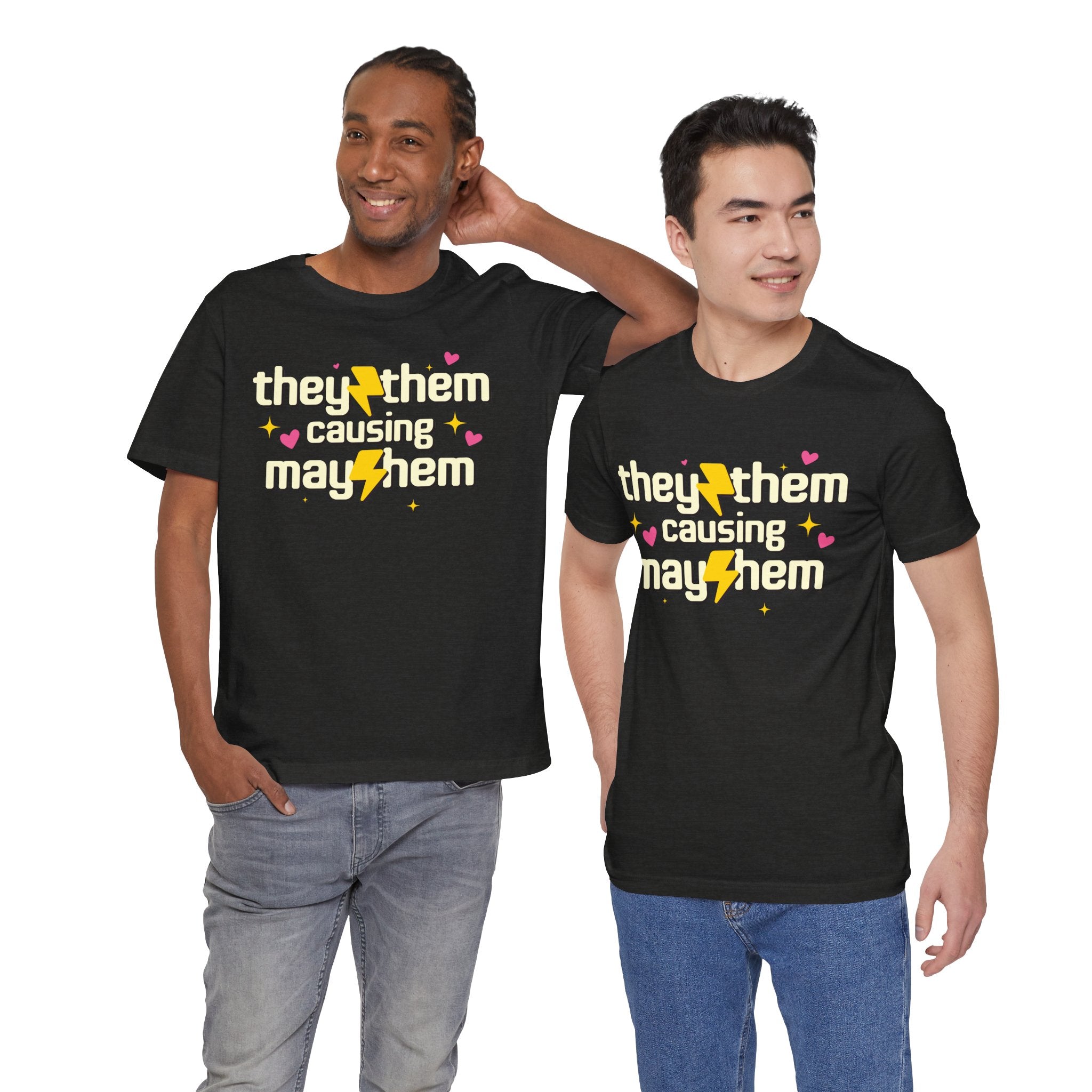 Two people wearing black t-shirts with 'they/them causing mayhem' text.