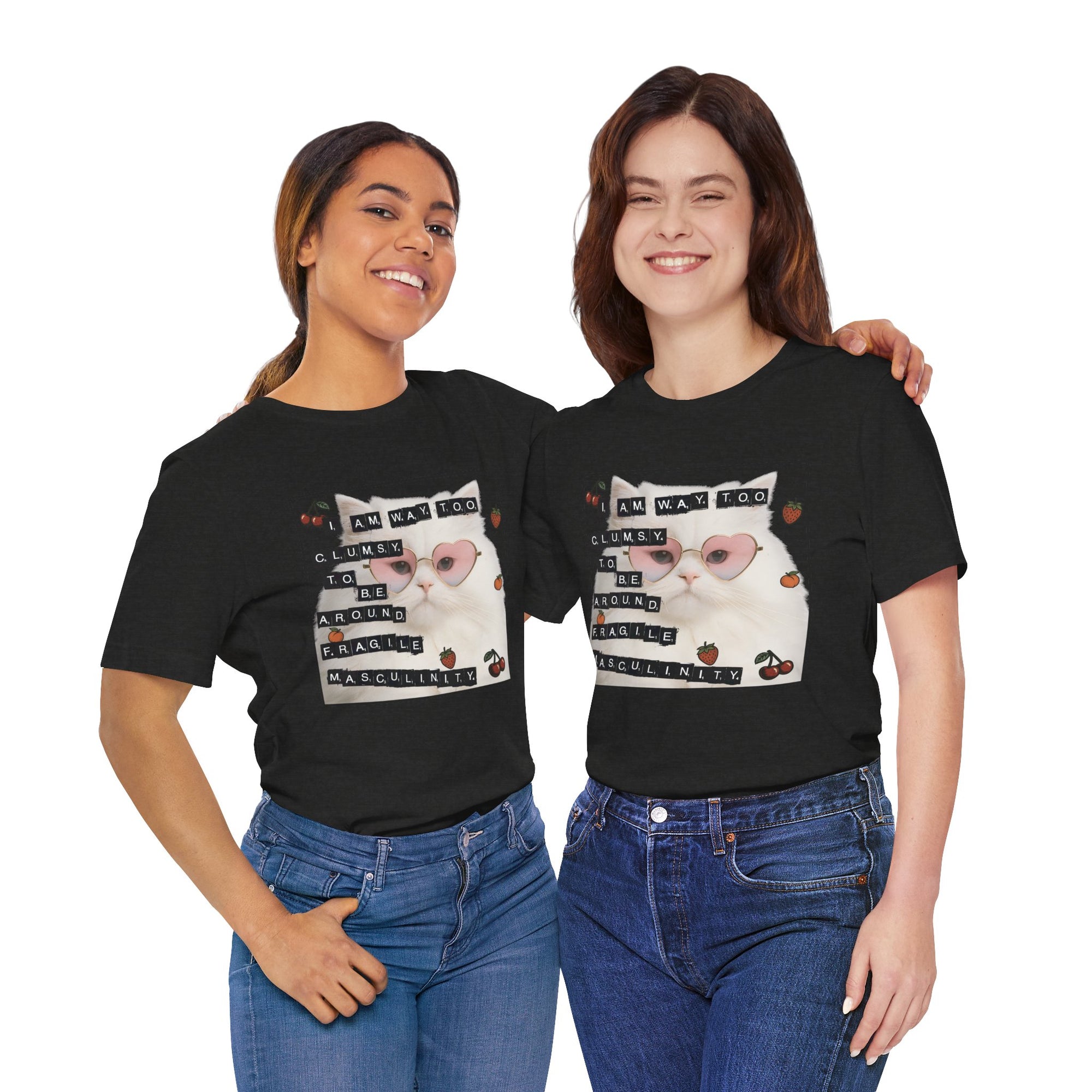 Two people wearing black t-shirt featuring a fluffy white cat in pink heart-shaped sunglasses with ransom-note style text that says “I am way too clumsy to be around fragile masculinity.”