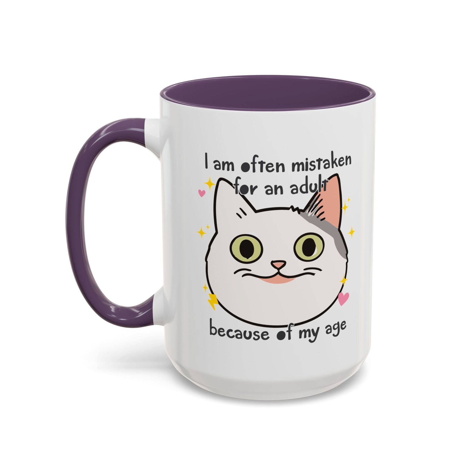 White ceramic mug with purple handle and interior featuring a cute wide-eyed cat face, hearts, sparkles, and the phrase “I am often mistaken for an adult because of my age.”

