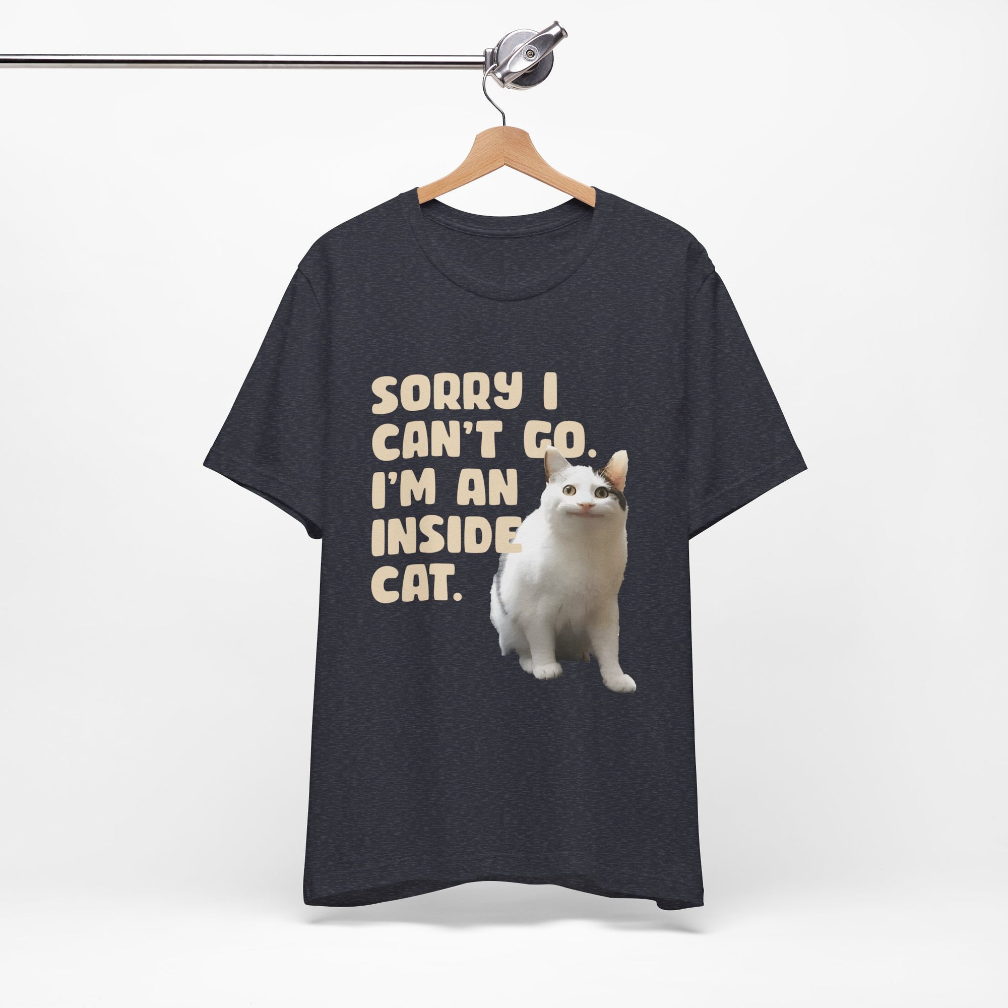 Black t-shirt with a white cat graphic and text on a hanger against a white background