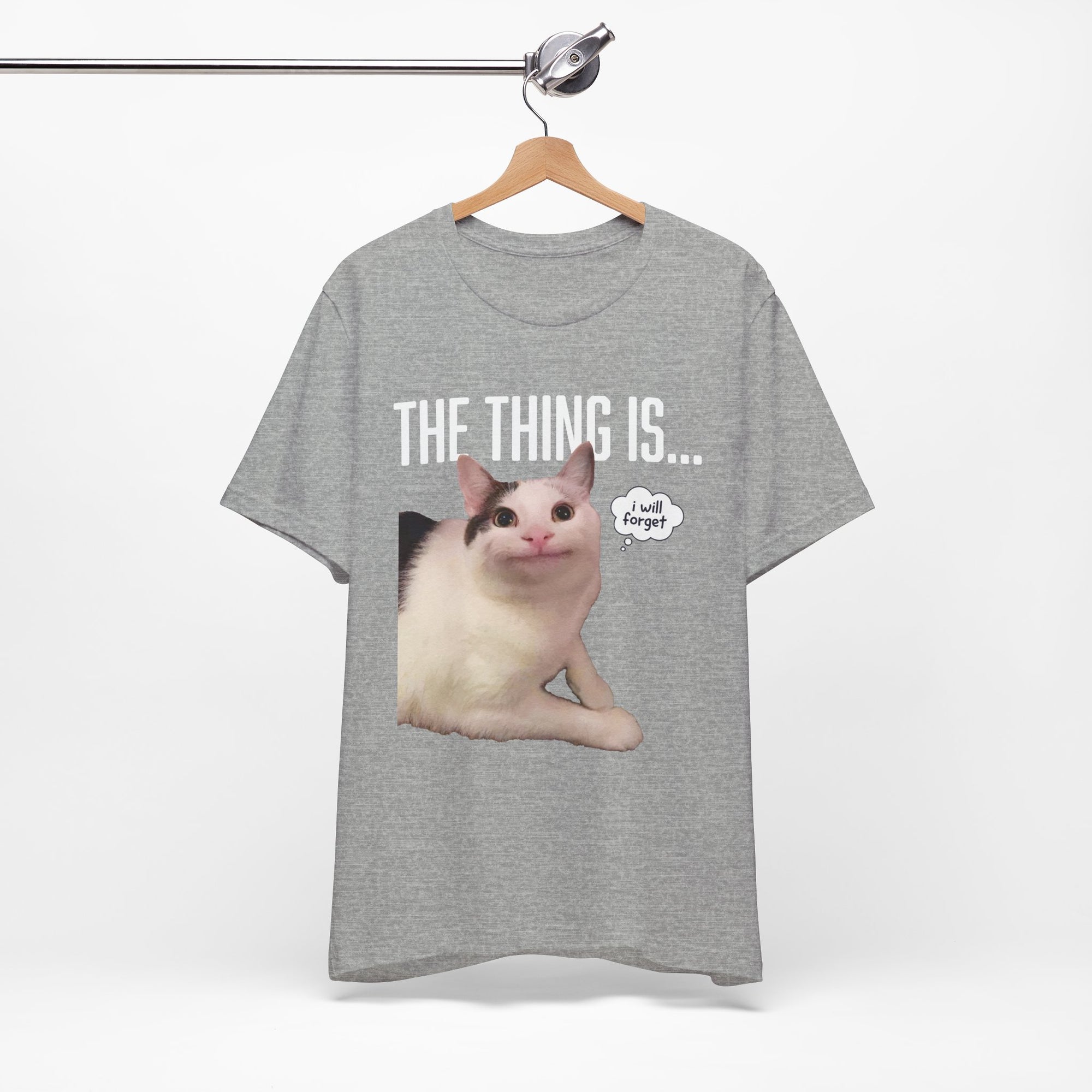 Gray t-shirt with a cat graphic and text on a hanger against a white background