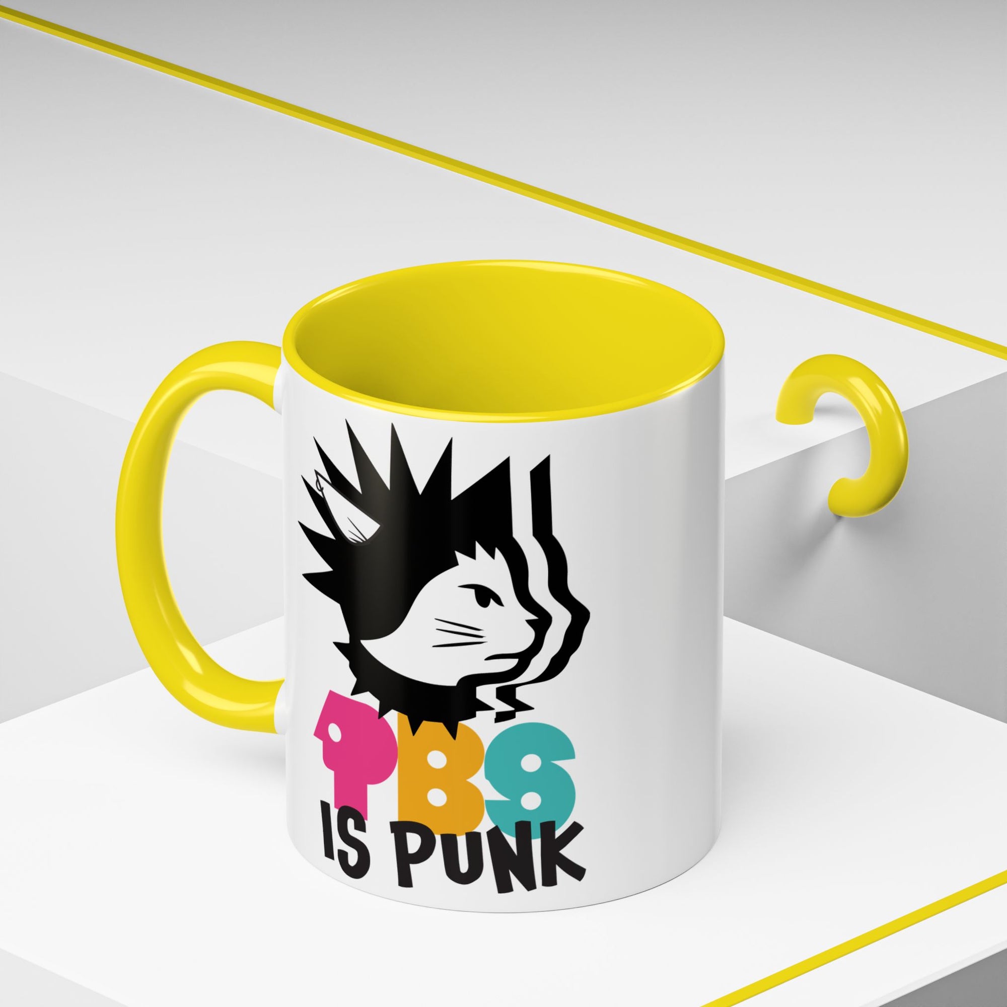 Mug with yellow interior and handle, featuring a graphic of a cat with spiky hair and colorful text on a white background.