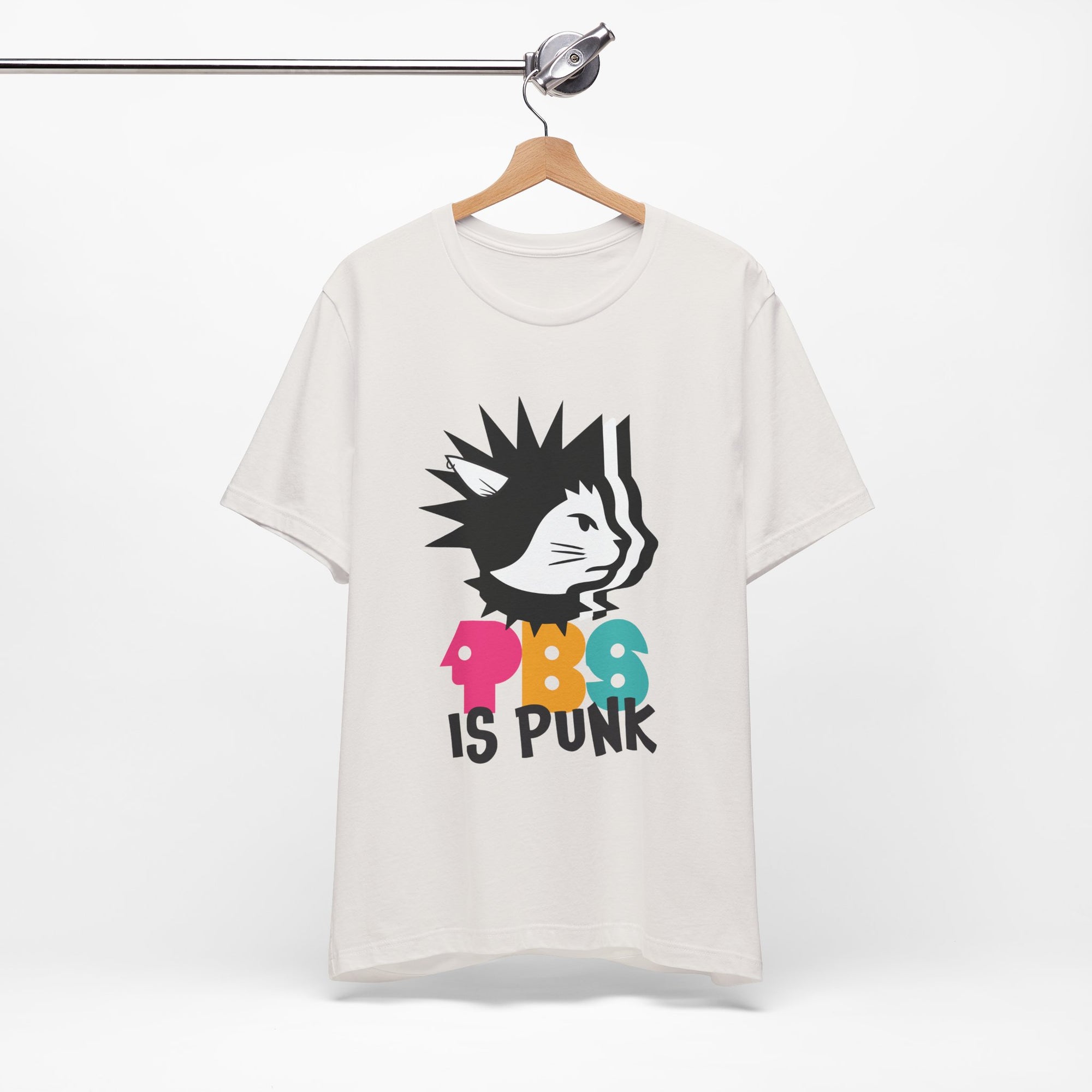 White t-shirt featuring a punk-style black cat graphic with colorful letters spelling “PBG” and black text that says “Is Punk.”
