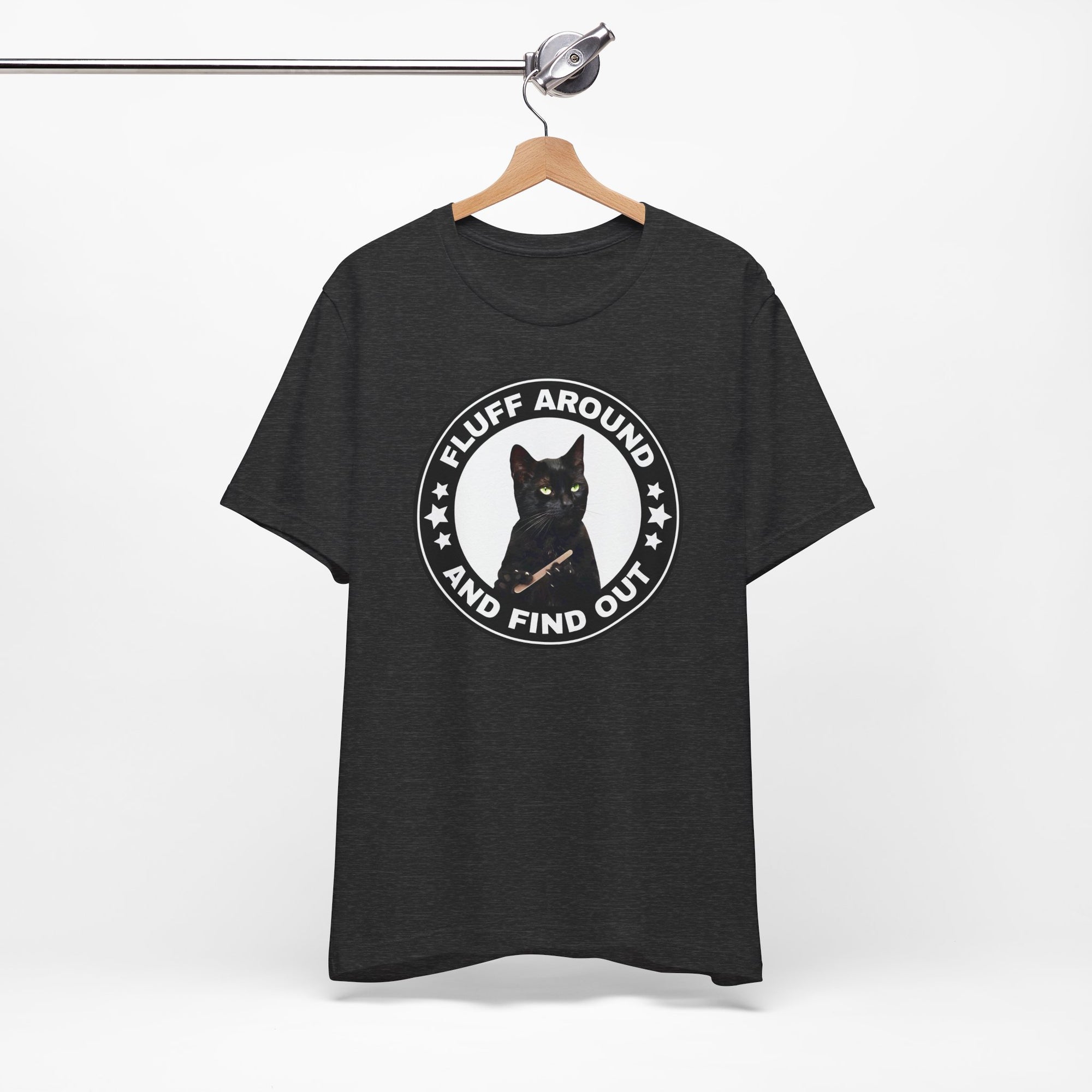 t-shirt featuring a circular badge design with a black cat and the phrase “Fluff Around and Find Out.”