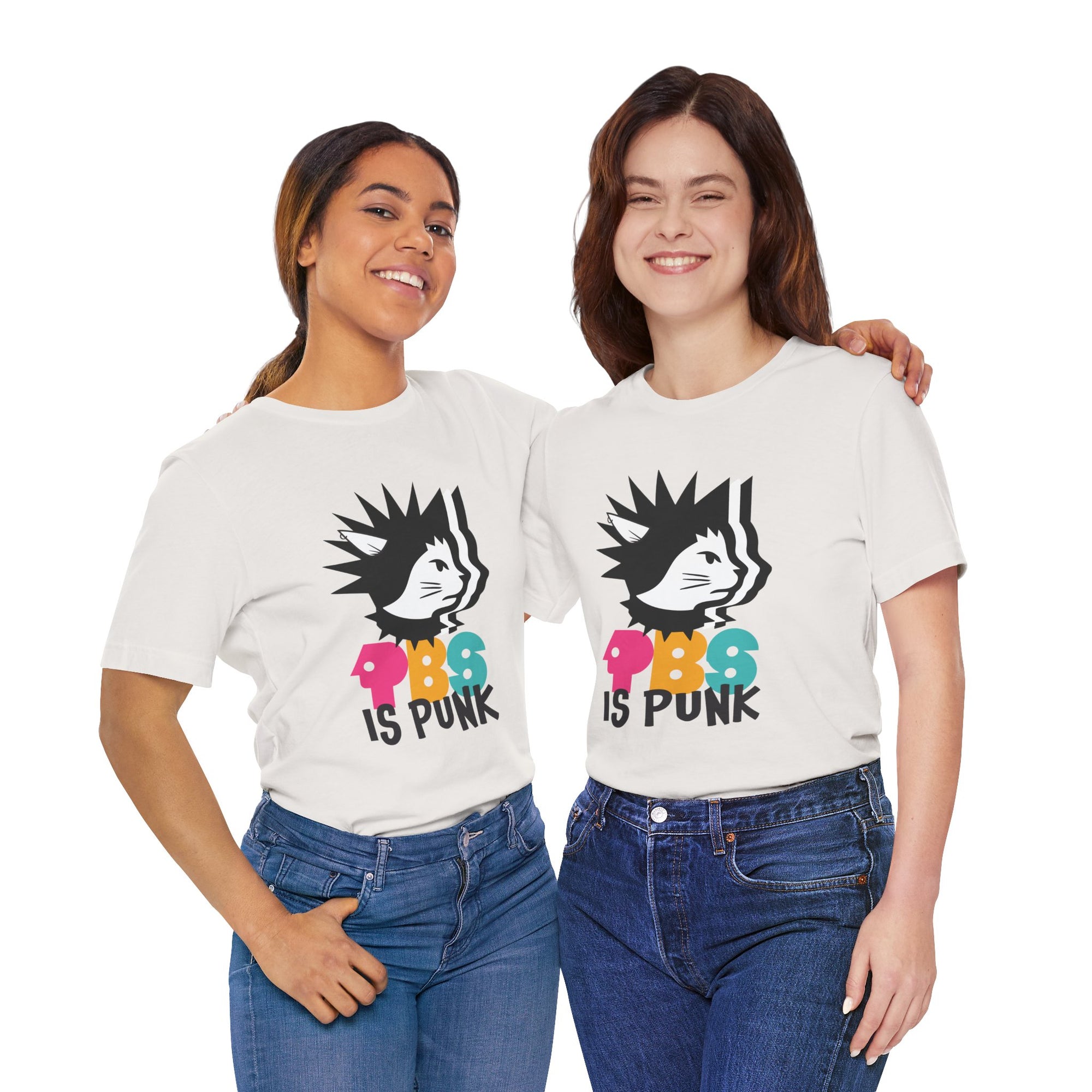 Two people wearing white t-shirt featuring a punk-style black cat graphic with colorful letters spelling “PBG” and black text that says “Is Punk.”
