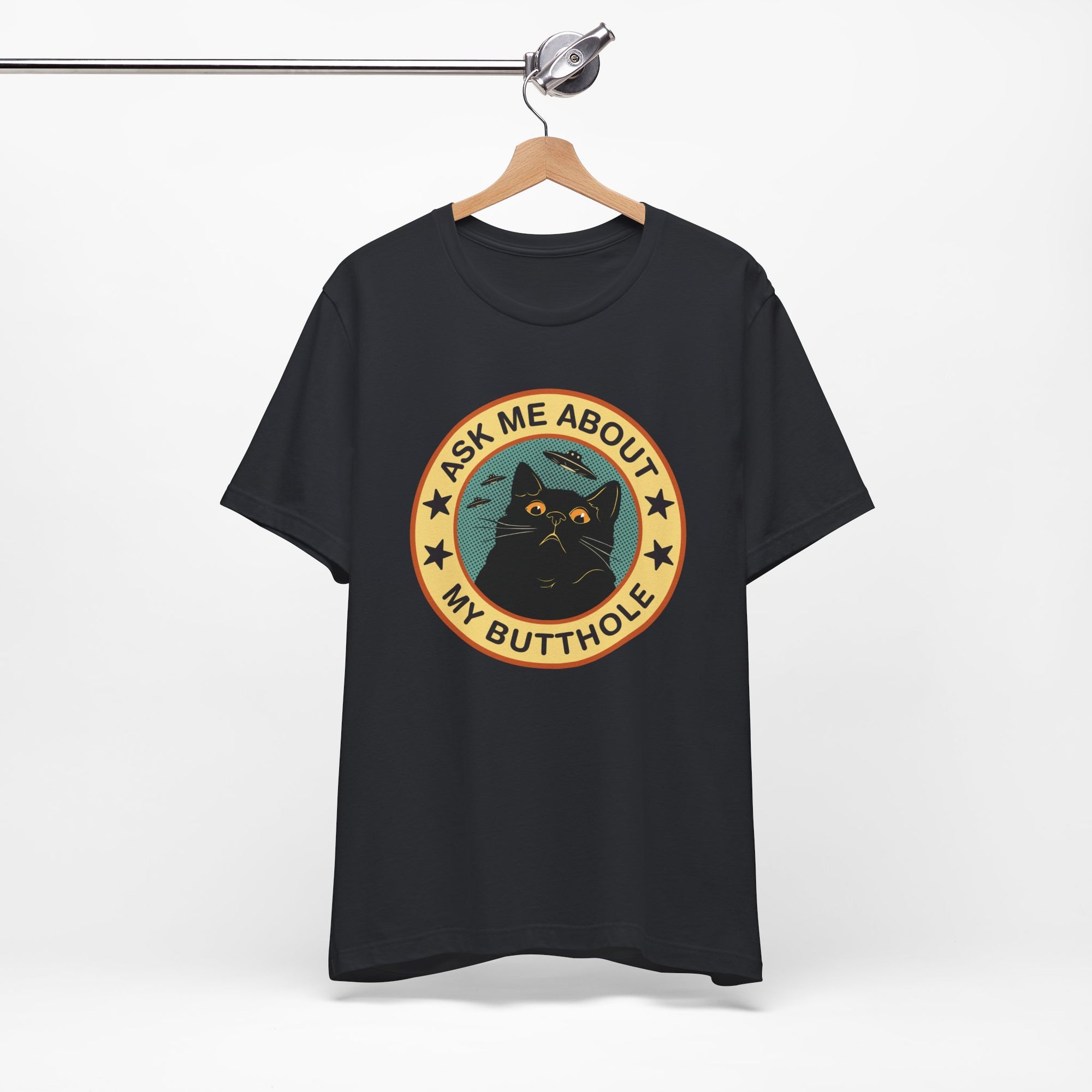 Black t-shirt with a graphic design featuring a cat and text on a hanger against a white background