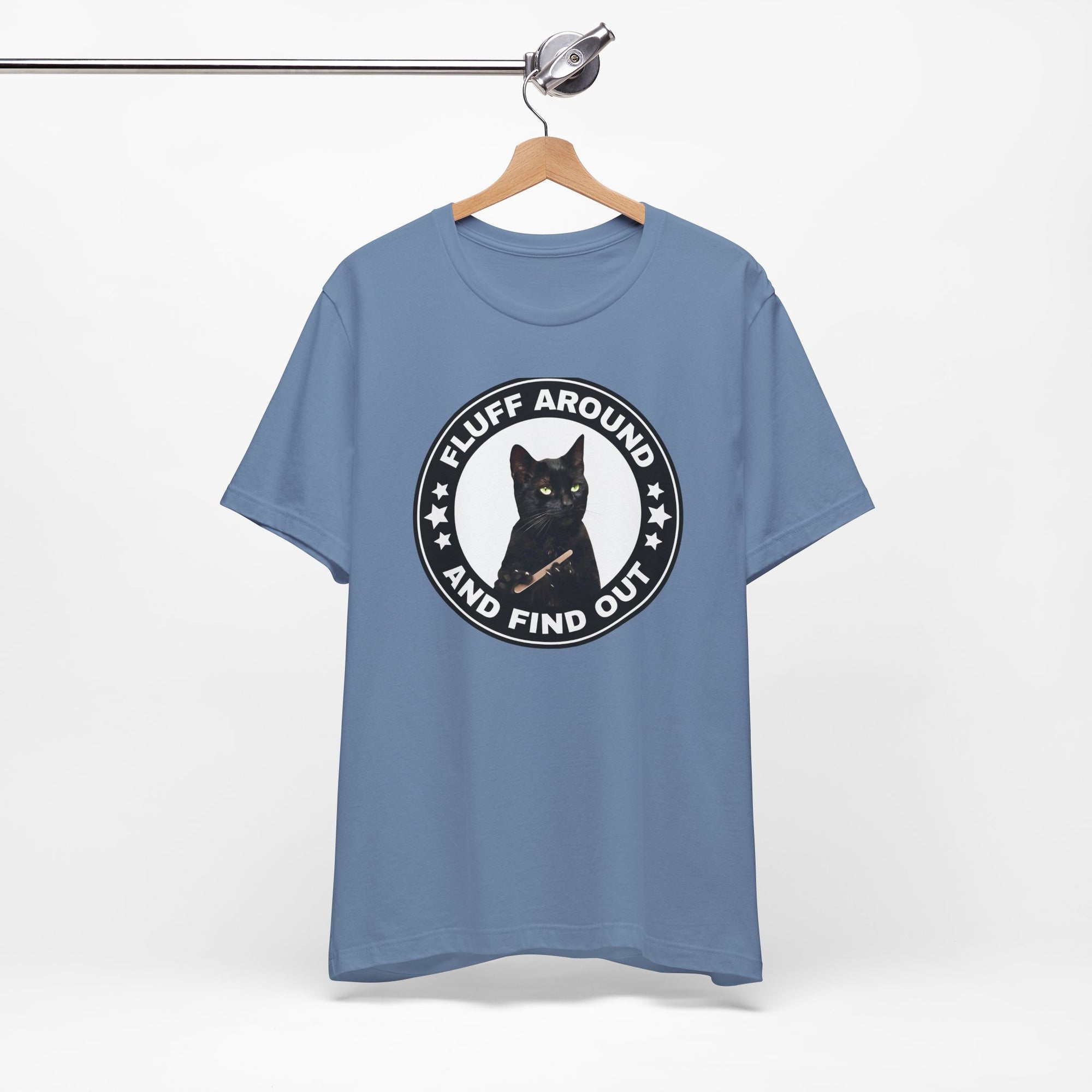 t-shirt featuring a circular badge design with a black cat and the phrase “Fluff Around and Find Out.”