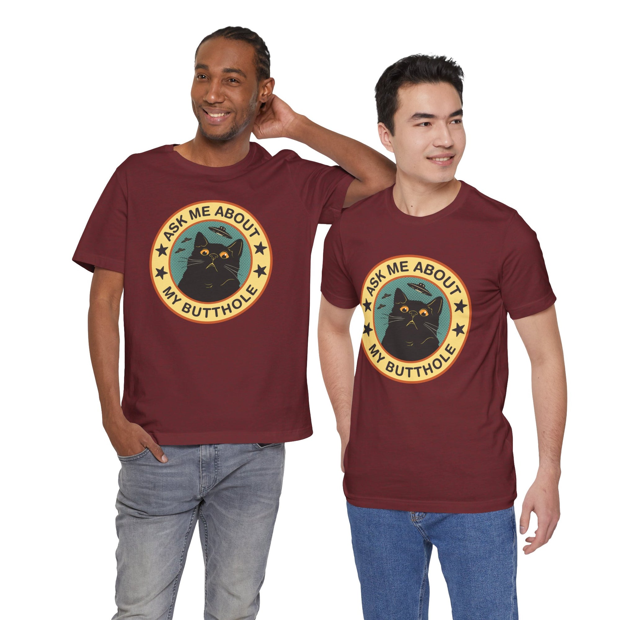 Two men wearing maroon t-shirts with a black cat graphic and text.