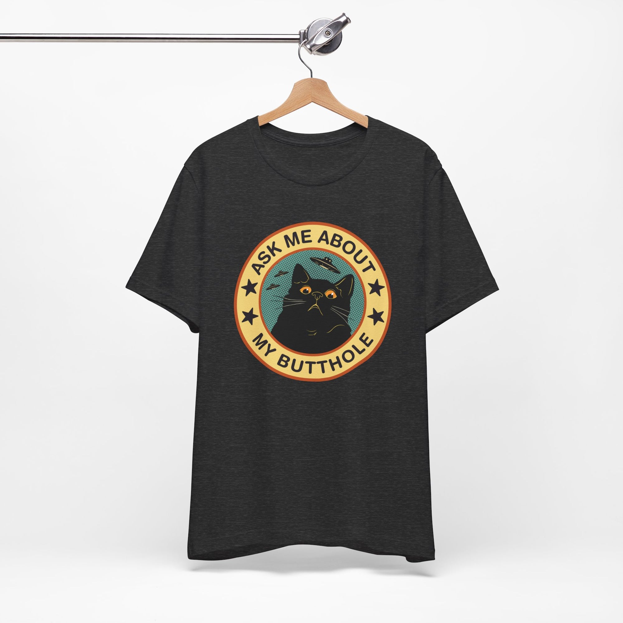Black t-shirt with a graphic design and text on a hanger against a white background
