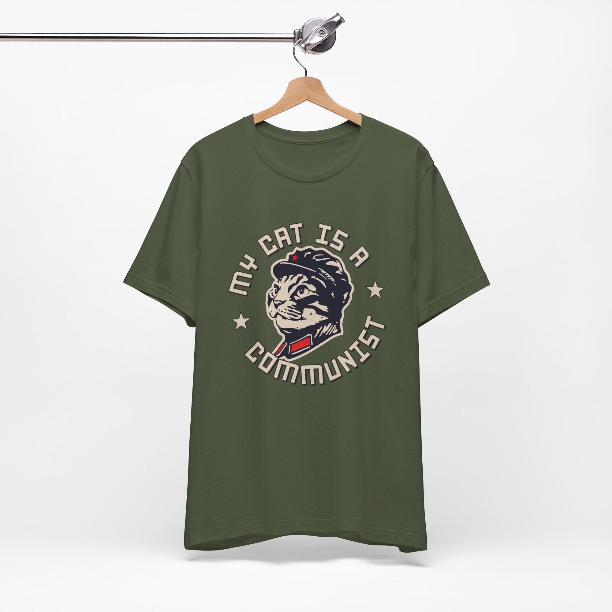 Green t-shirt with a graphic design of a cat and text on a hanger against a white background
