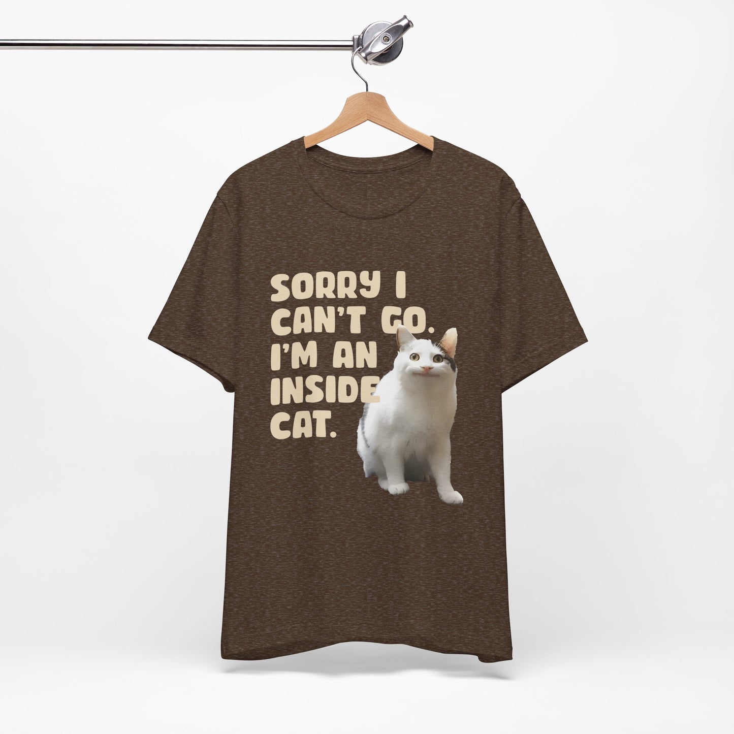 Brown t-shirt with a cat graphic and text on a hanger against a white background