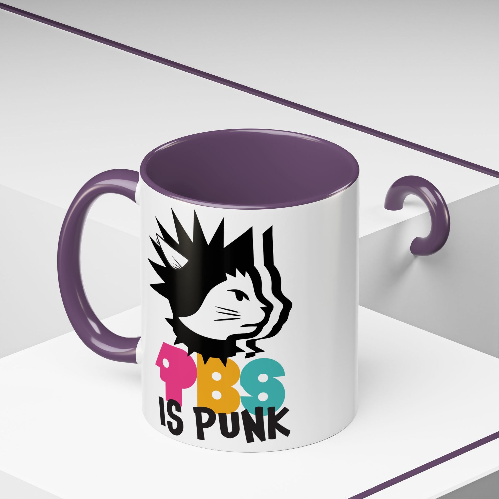 Mug with a graphic design of a cat with spiky hair and colorful text on a white background