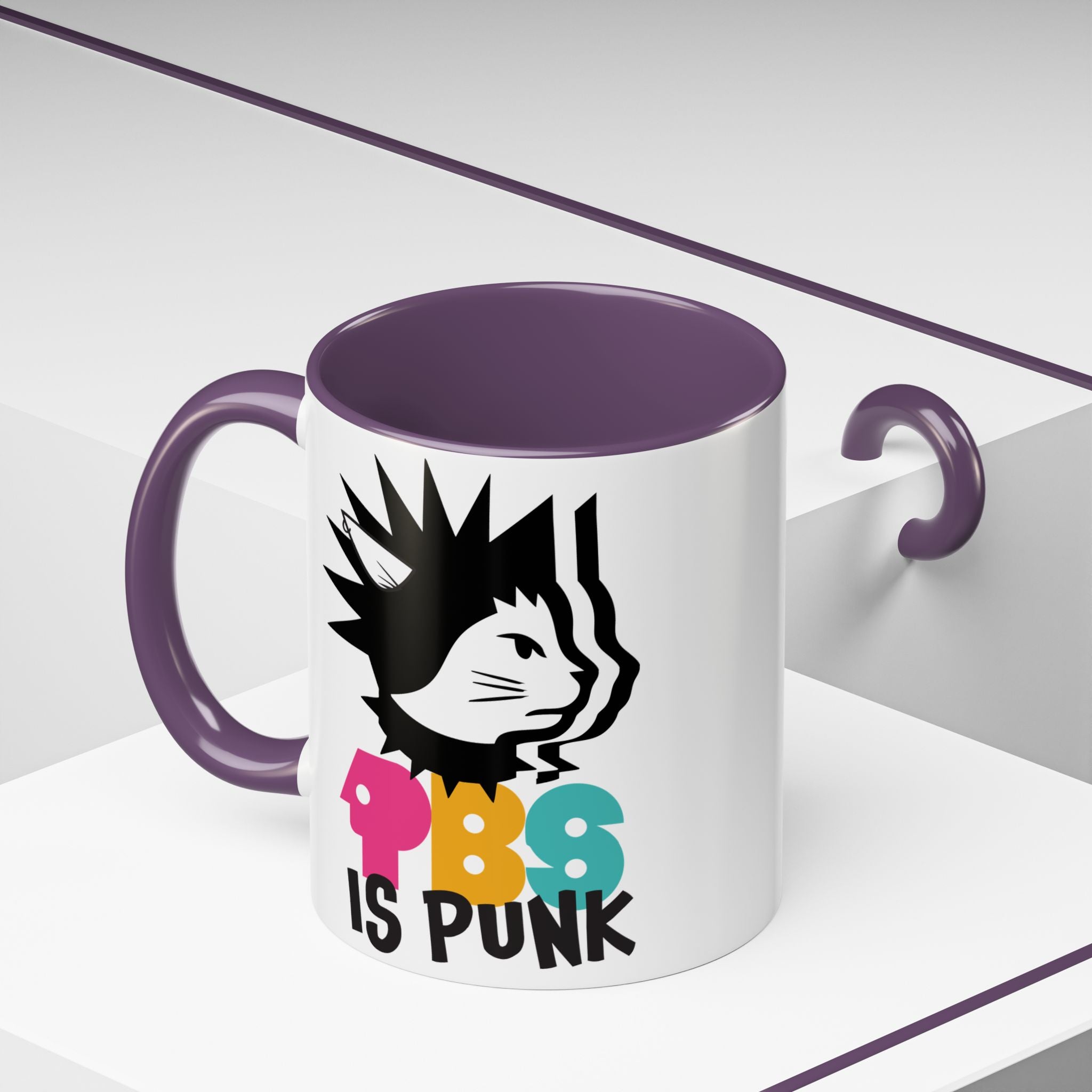 Mug with a graphic design of a cat with spiky hair and colorful text on a white background