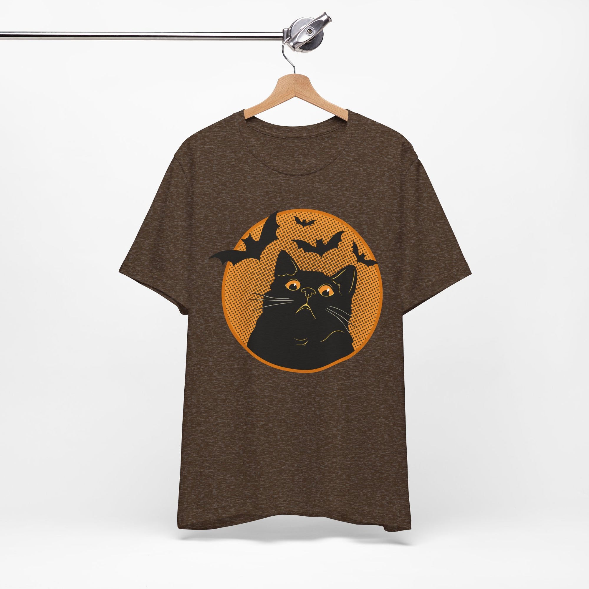 Brown t-shirt featuring a retro-style black cat graphic with orange moon, flying bats, and Halloween-inspired details.