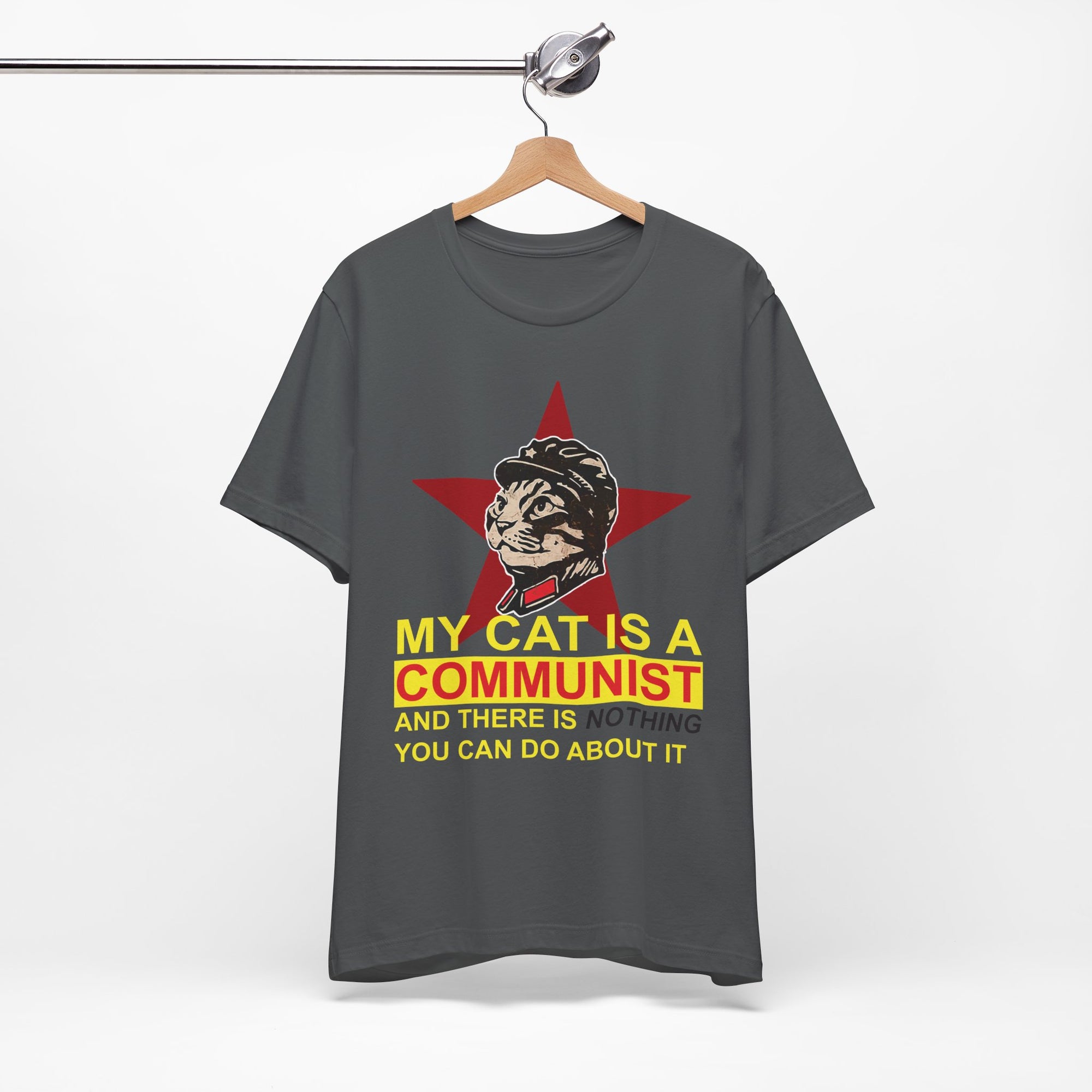 Gray t-shirt with a graphic of a cat in a communist uniform and text on a hanger against a white background