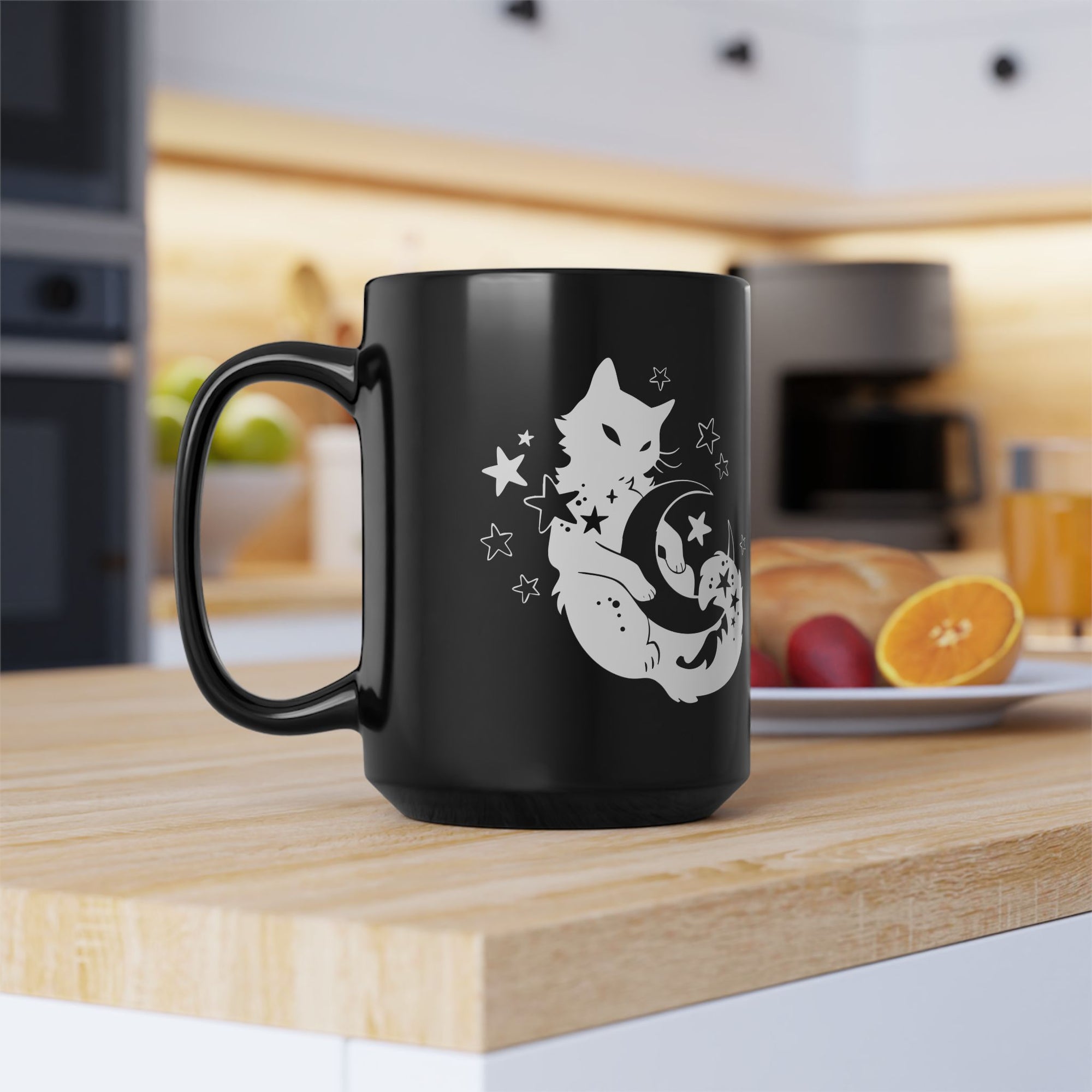 Black mug with a white cat design on a kitchen counter