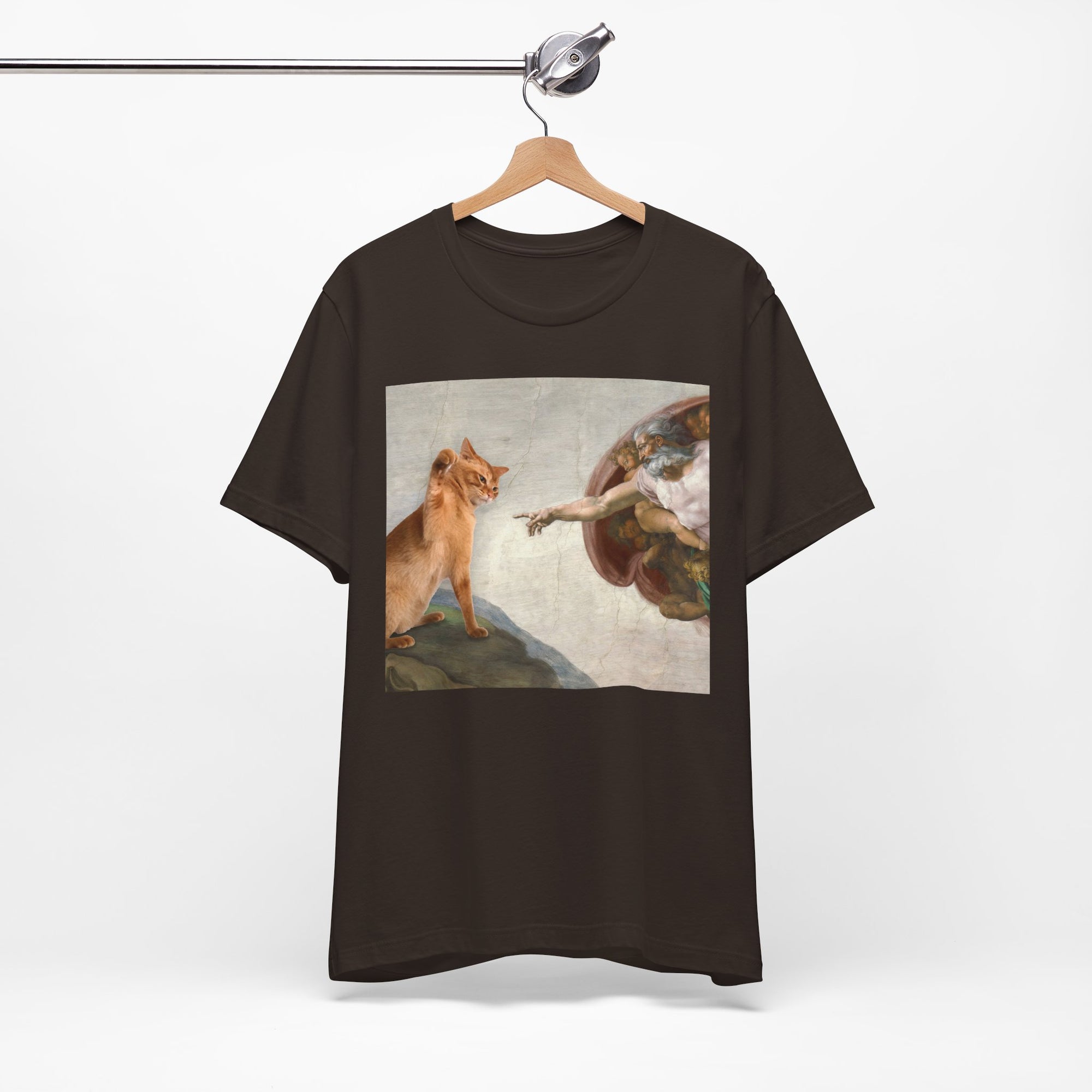 Black t-shirt with a graphic of a cat and classical painting on a hanger against a white background