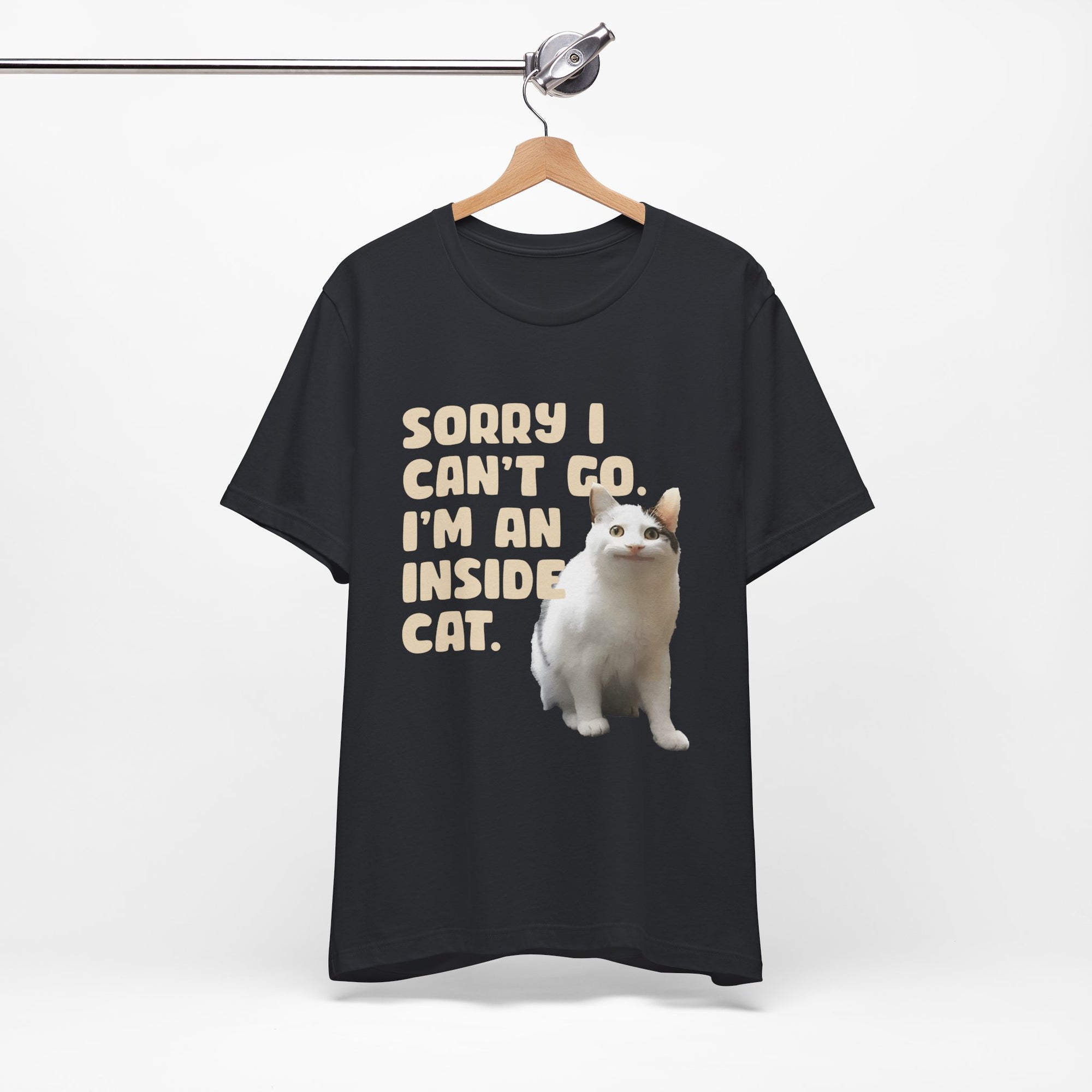 Black t-shirt with a white cat graphic and text on a hanger against a white background