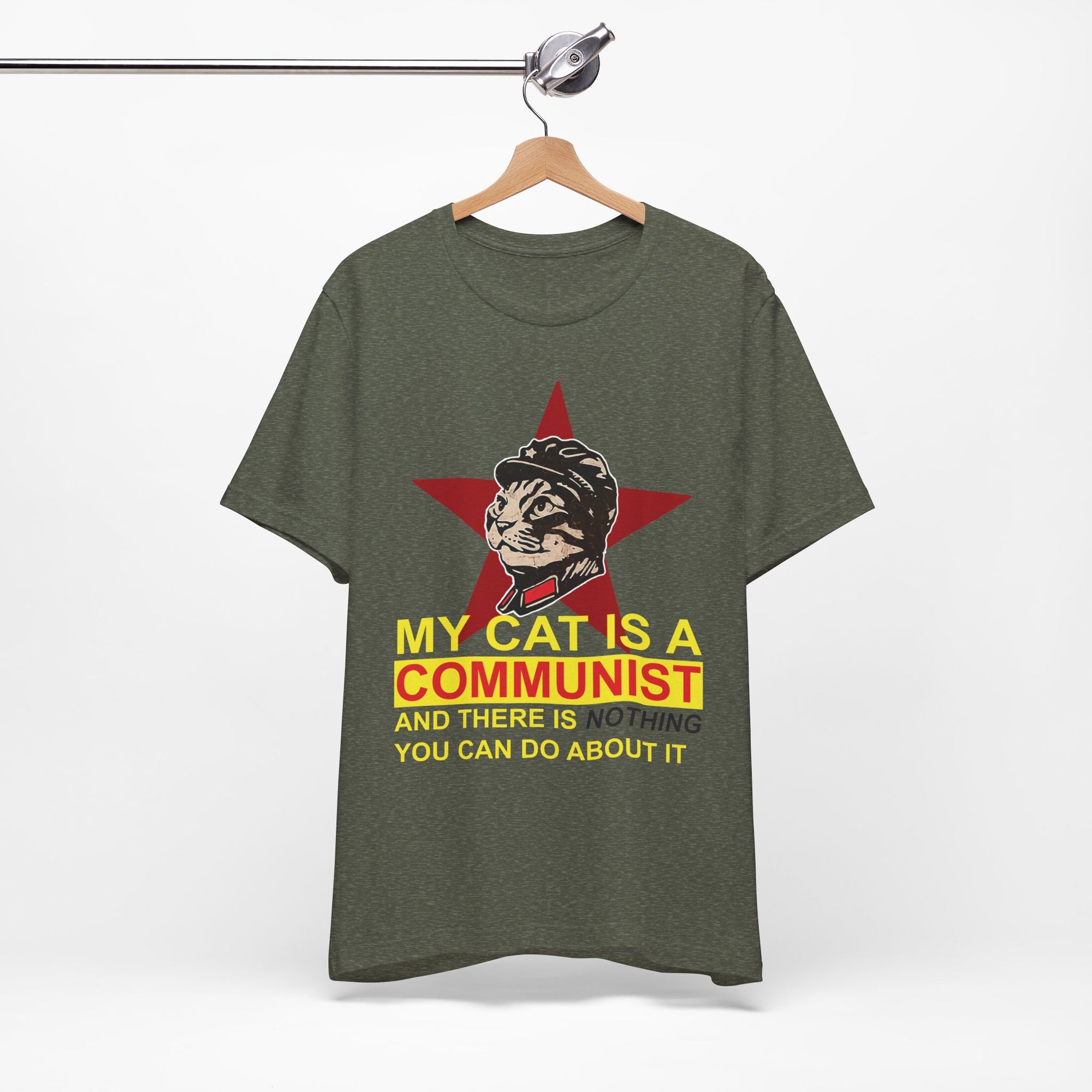 Green t-shirt with a graphic of a cat in a communist uniform and text on a hanger against a white background