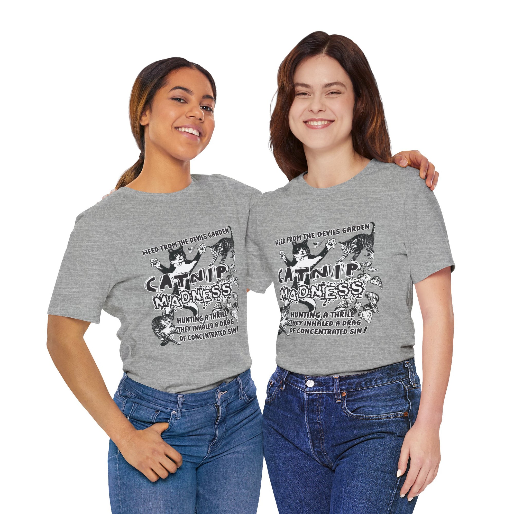 Two women wearing gray t-shirts with a graphic design and text.