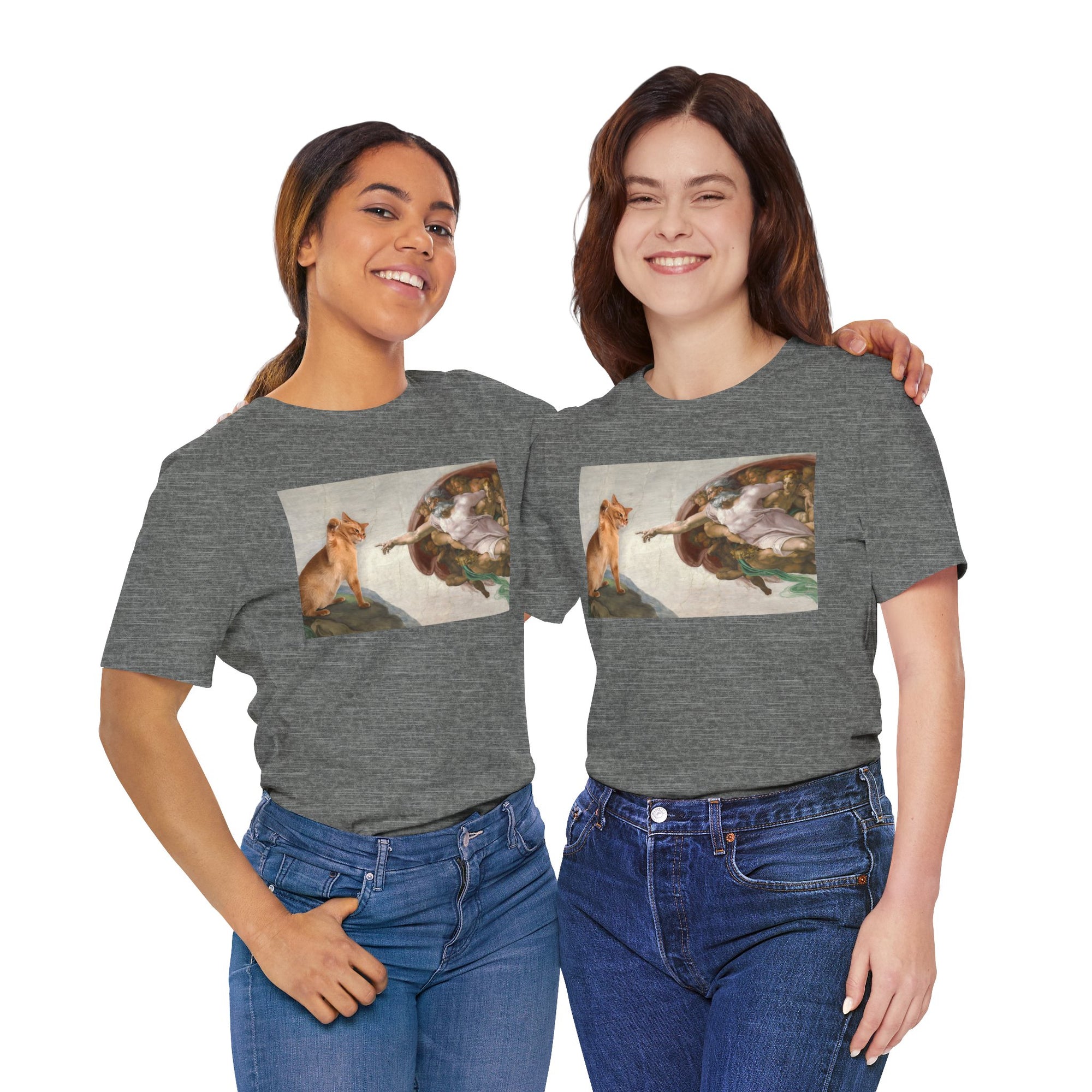 Two women wearing gray t-shirts with a graphic of a cat and god on a white background