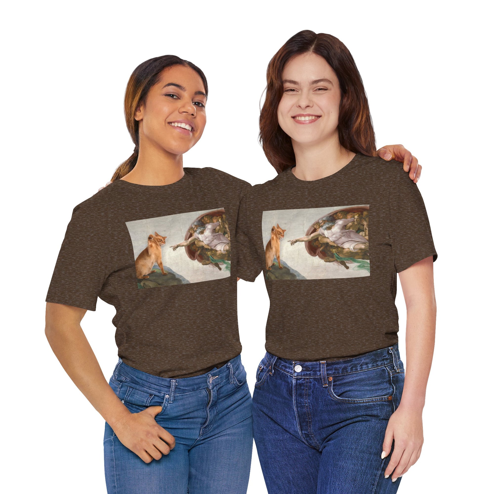 Two women wearing matching brown t-shirts with a graphic design of a cat and god 