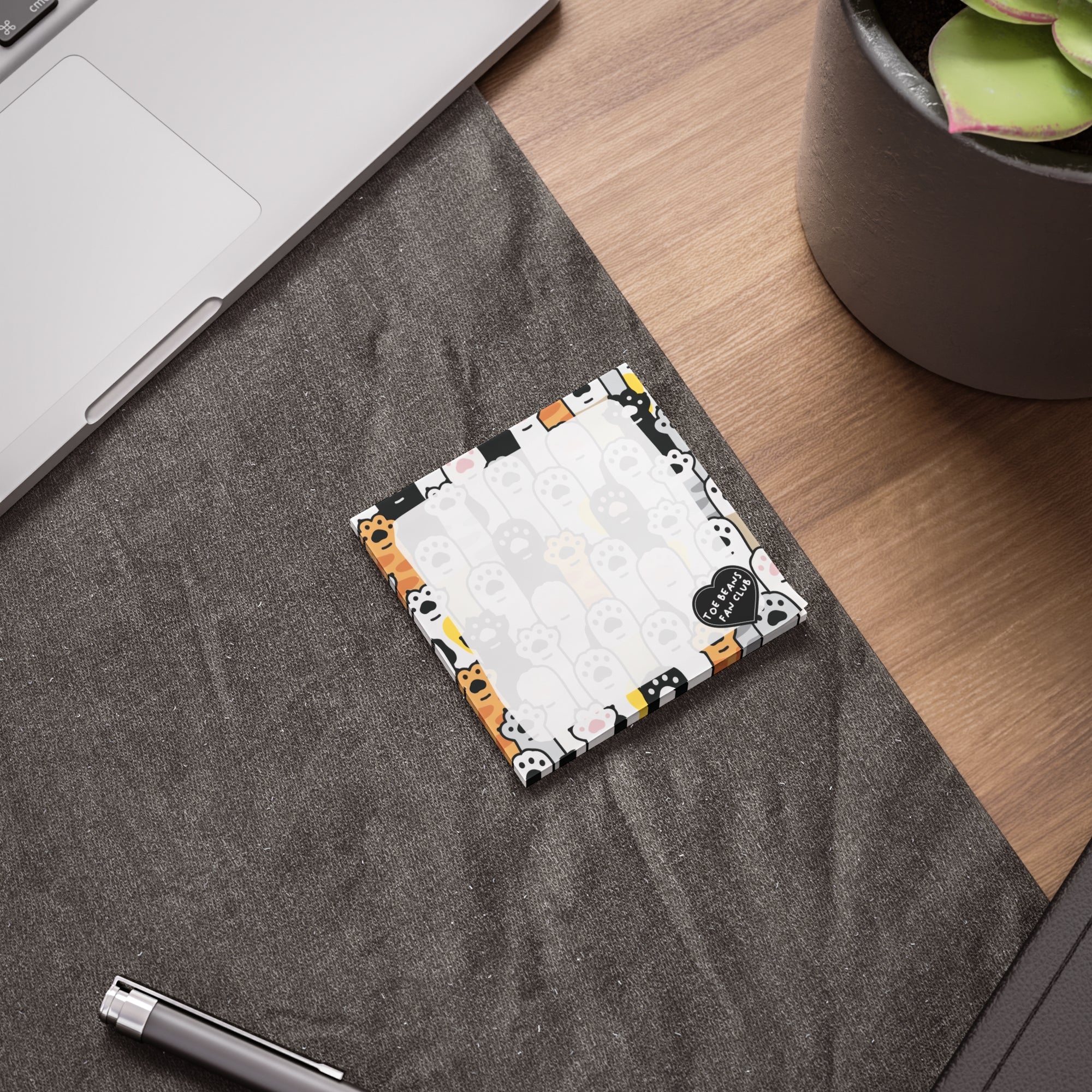 Cute cat-themed sticky note pad with a repeating toe bean and cat paw border, a small “Toe Beans Fan Club” badge, and a lighter center area for writing notes.
