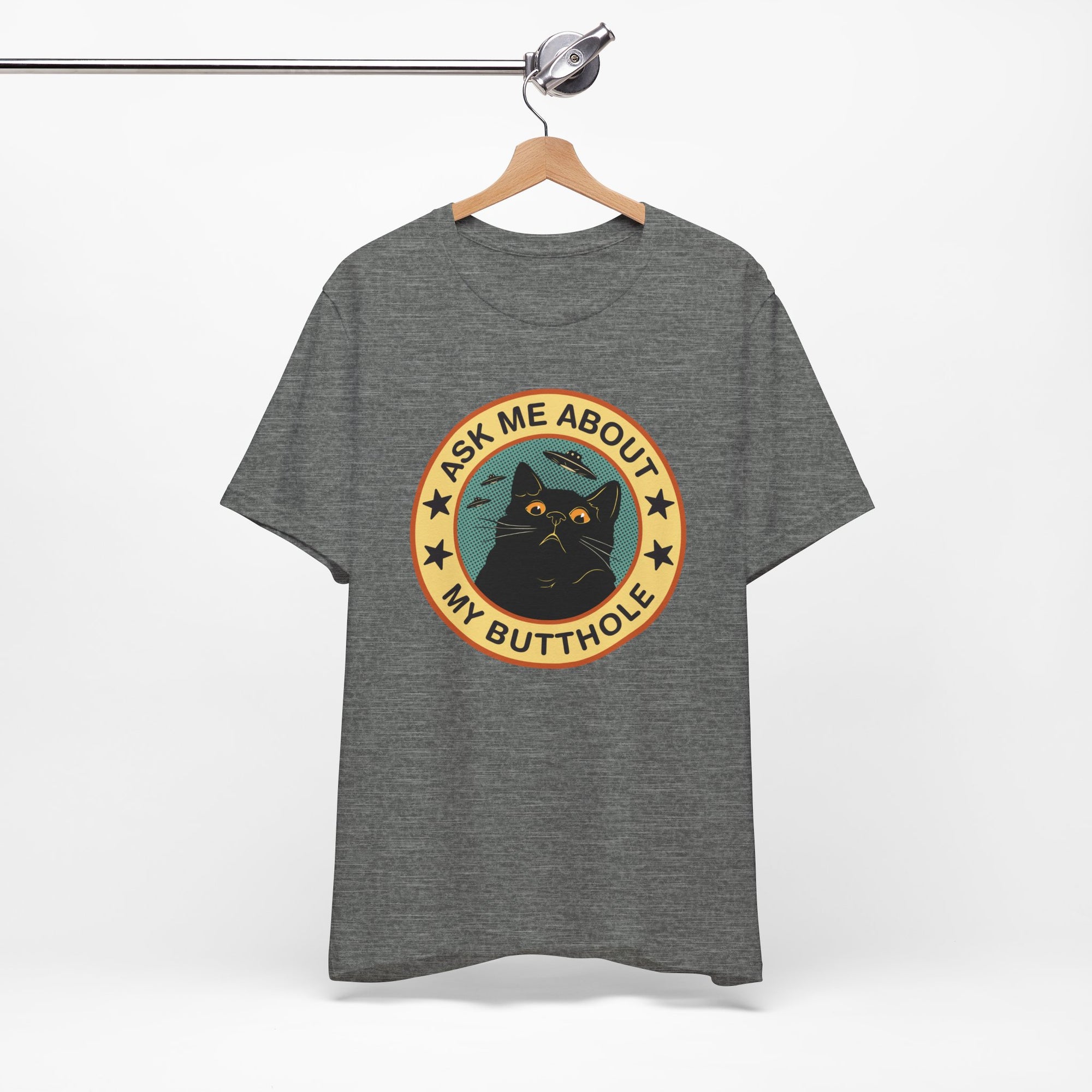 Gray t-shirt with a graphic design featuring a cat and text on a hanger against a white background